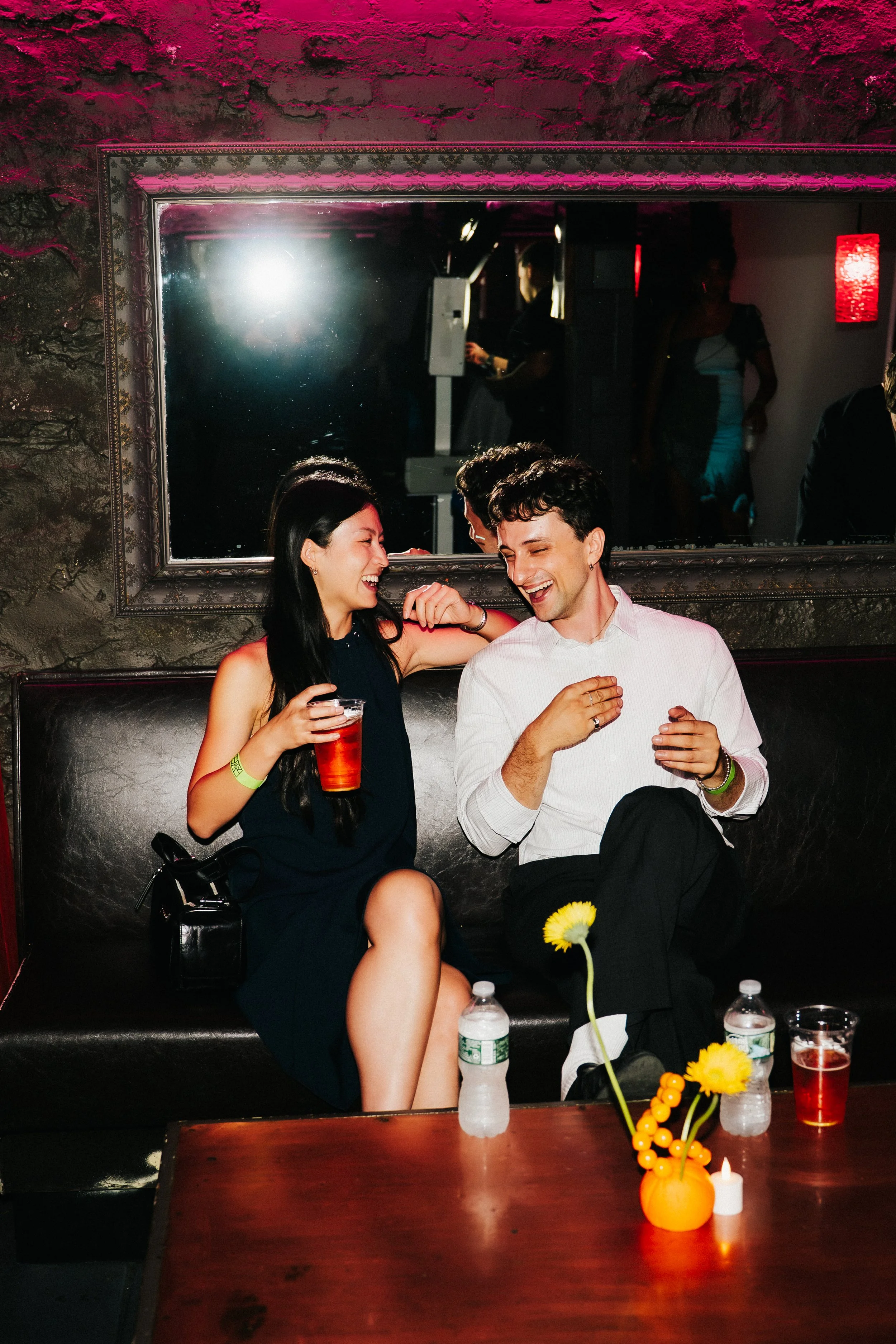 Rager wedding with technicolor wedding flowers adorned with citrus on the Lower East Side at the Bowery Ballroom. Photo by Inez Valencia.