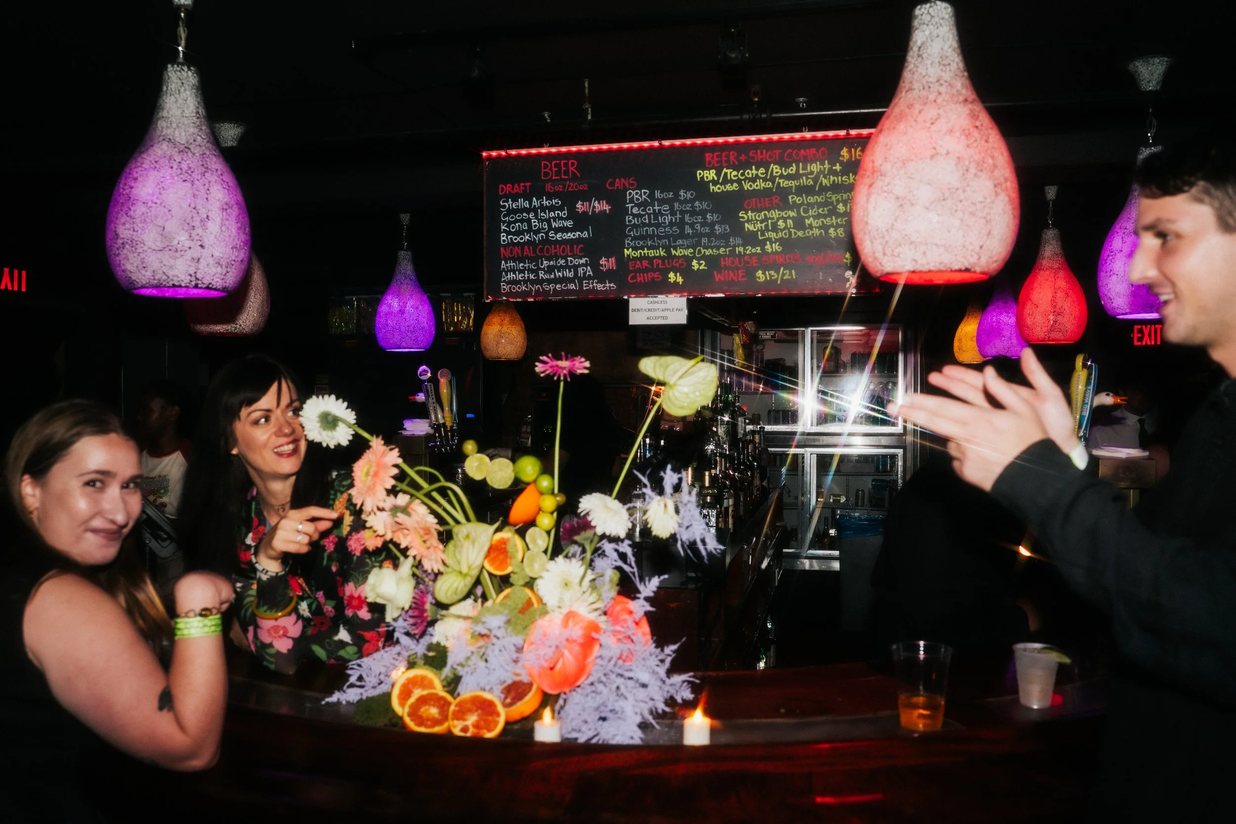 Rager wedding with technicolor wedding flowers adorned with citrus on the Lower East Side at the Bowery Ballroom. Photo by Inez Valencia.