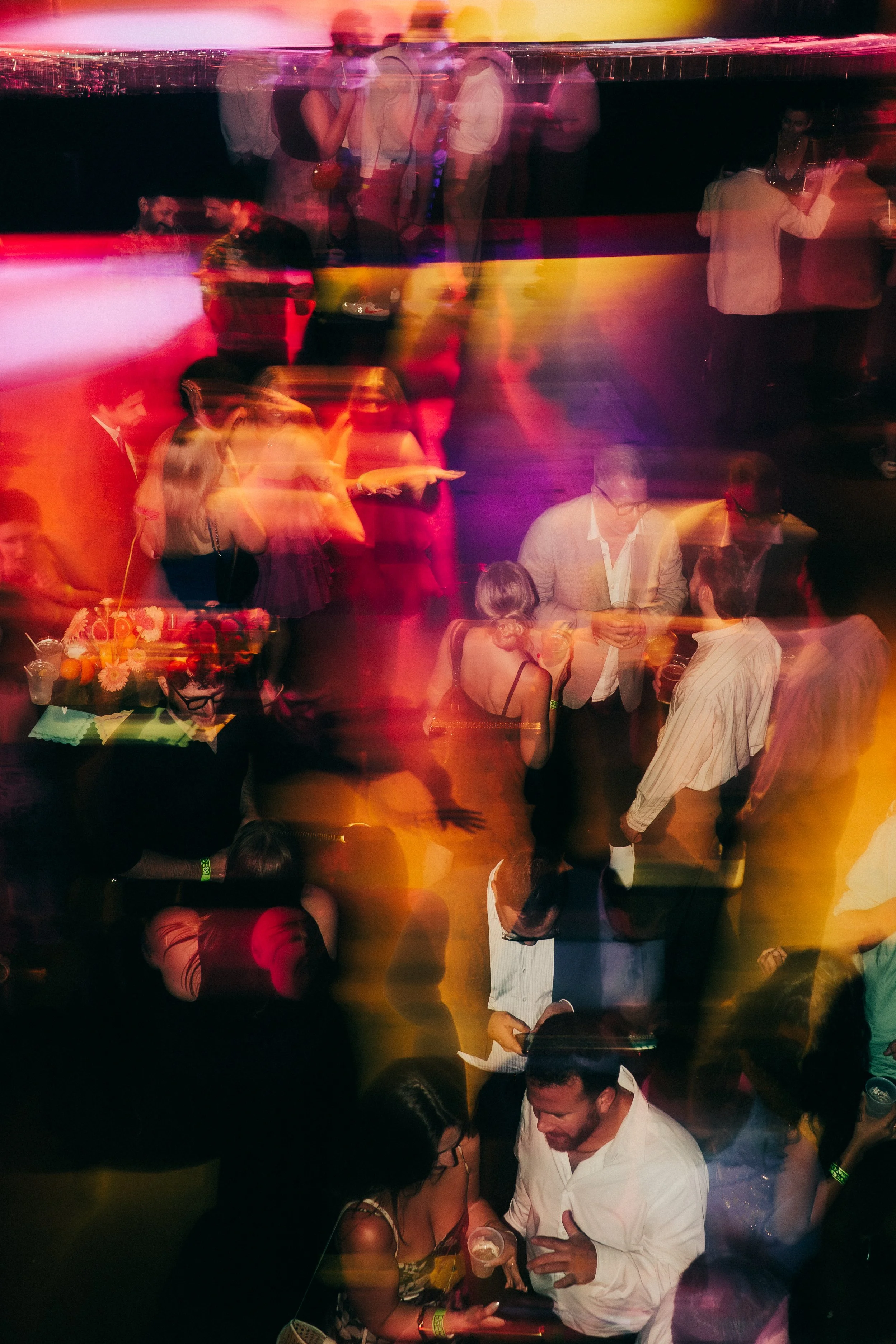 Rager wedding with technicolor wedding flowers adorned with citrus on the Lower East Side at the Bowery Ballroom. Photo by Inez Valencia.