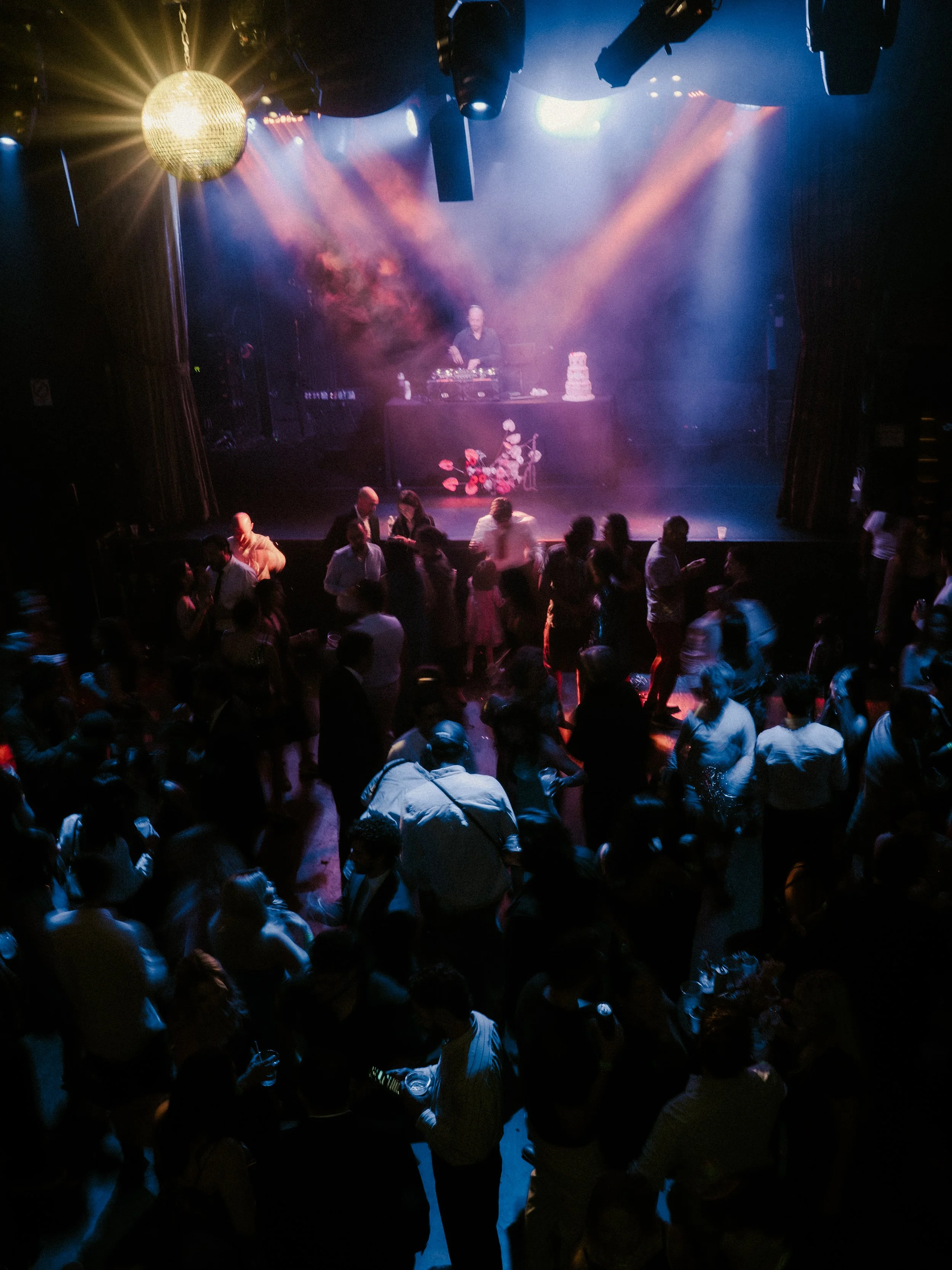 Rager wedding with technicolor wedding flowers adorned with citrus on the Lower East Side at the Bowery Ballroom. Photo by Inez Valencia.