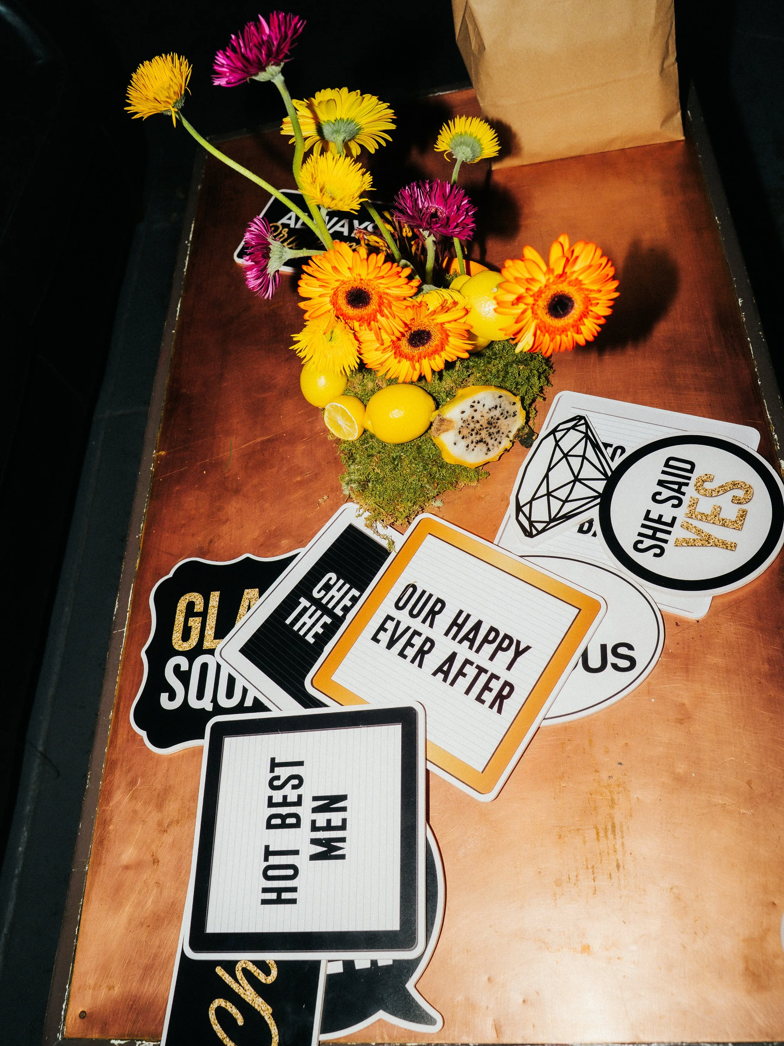 Rager wedding with technicolor wedding flowers adorned with citrus on the Lower East Side at the Bowery Ballroom. Photo by Inez Valencia.