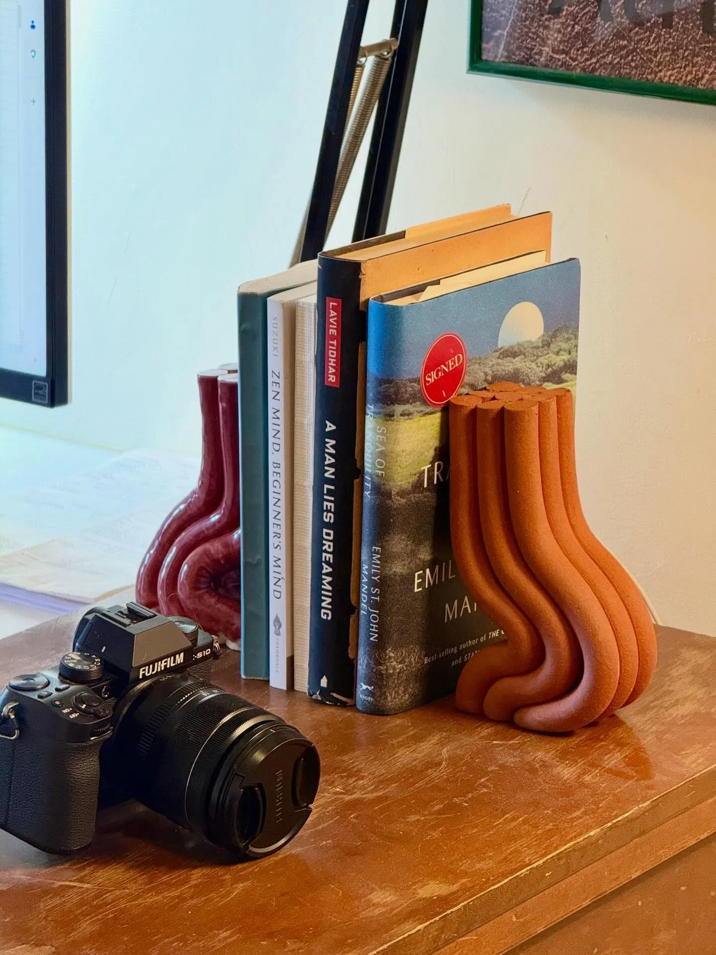 A mismatched pair of bookends in use! I love the warmth of that raw red clay.