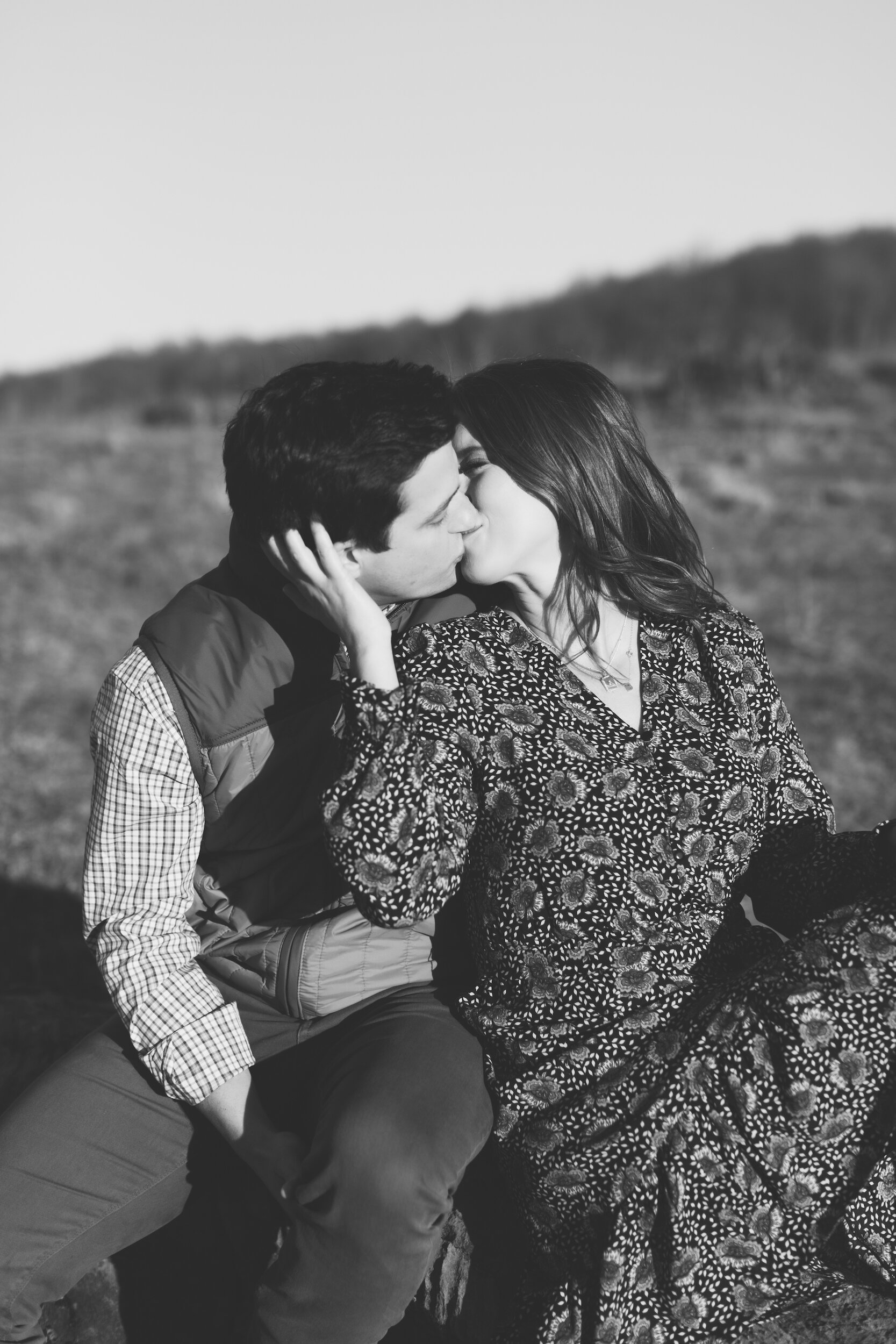 Couple Kissing During Family Farm Winter Engagement Photo Session