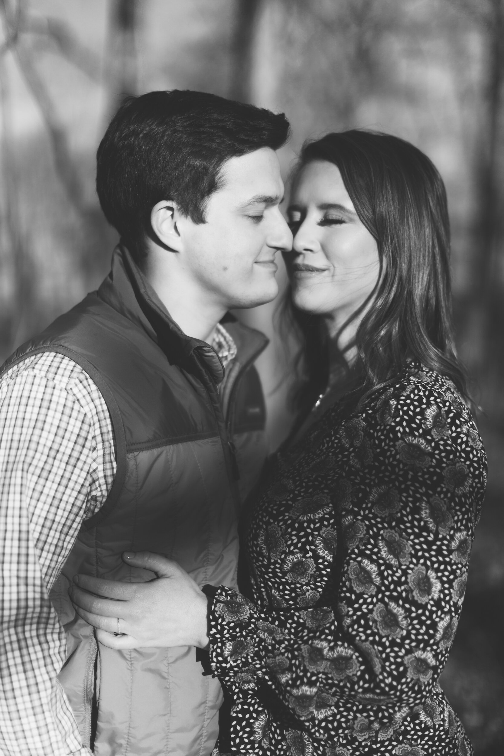 Couple Snuggled Close During Family Farm Winter Engagement Photo Session