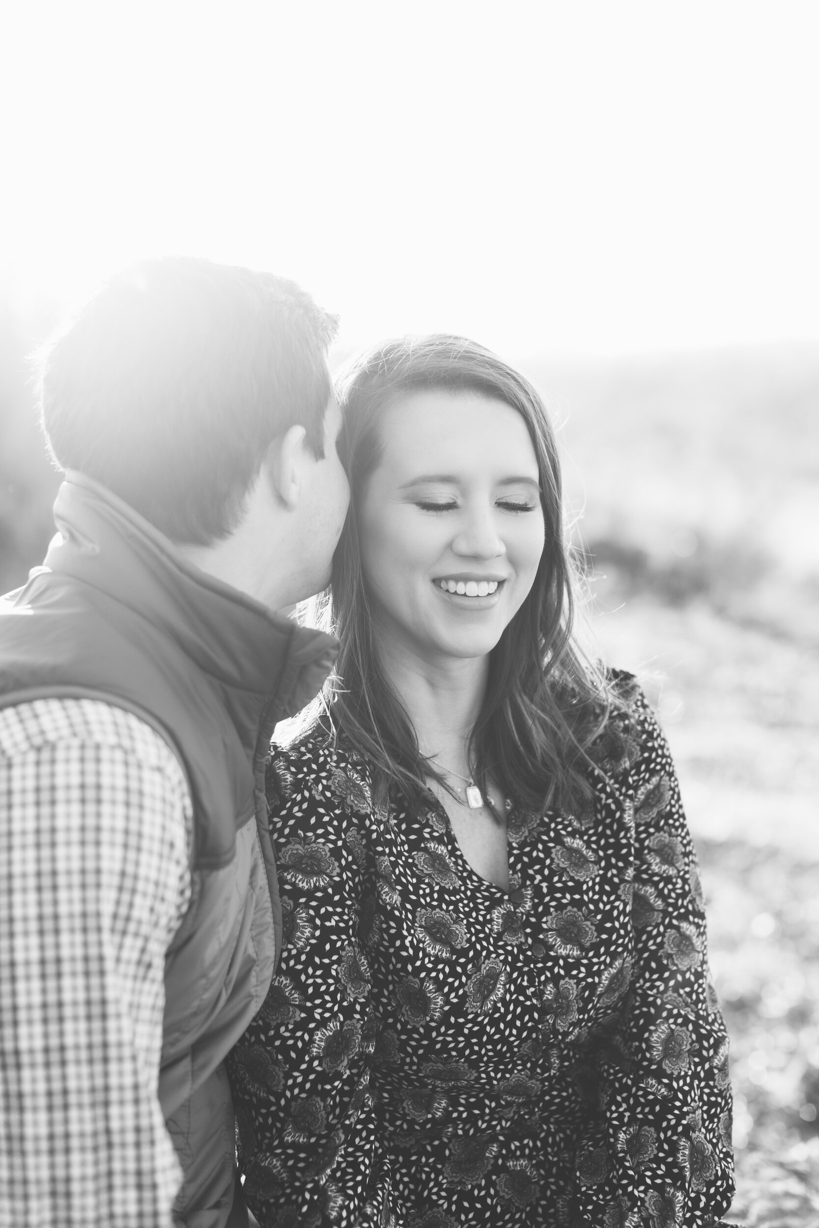 Couple Watching Sunset During Family Farm Winter Engagement Photo Session