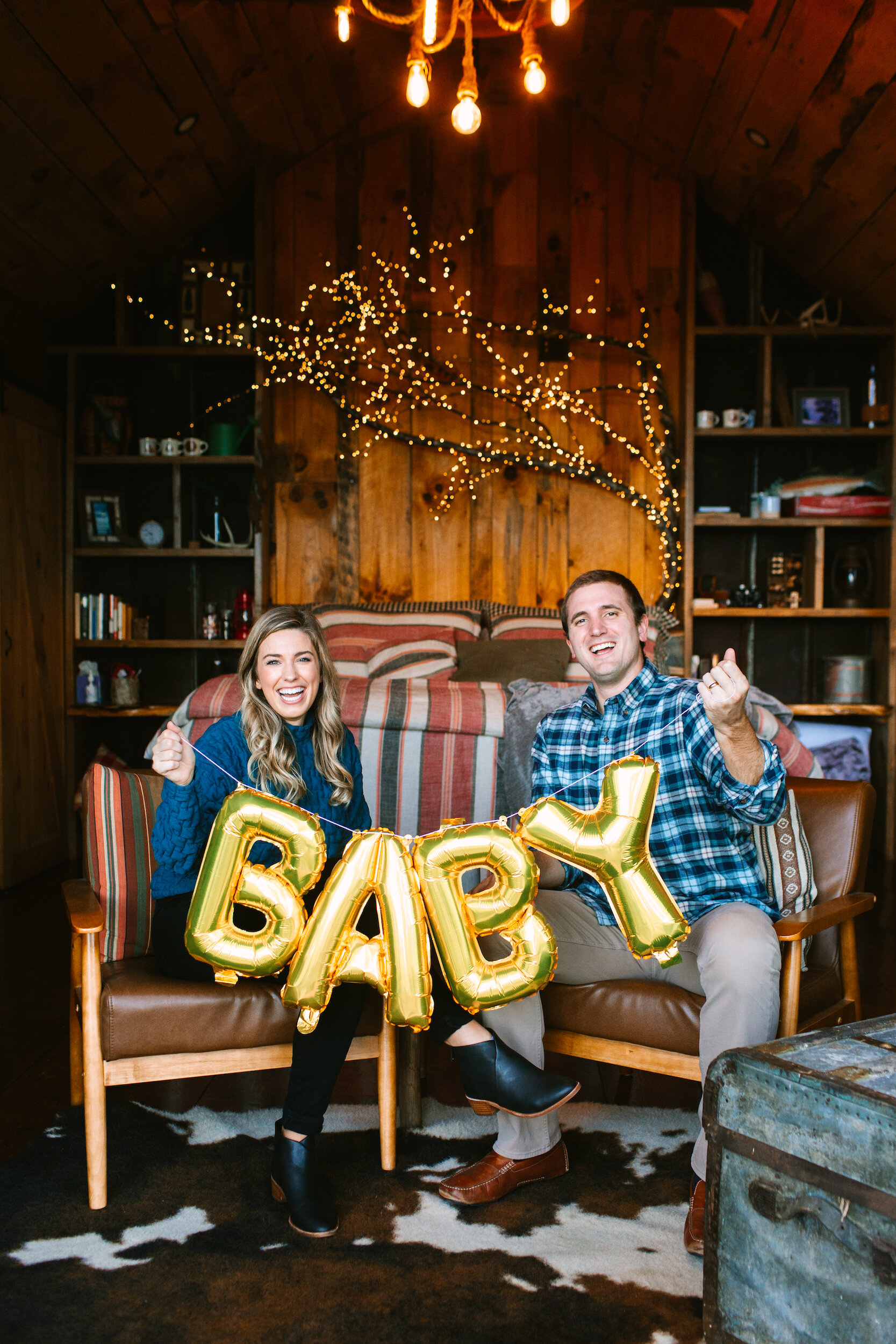 Couple Holding B-A-B-Y Balloons for Baby Announcement Photos at Selah Ridge Treesort
