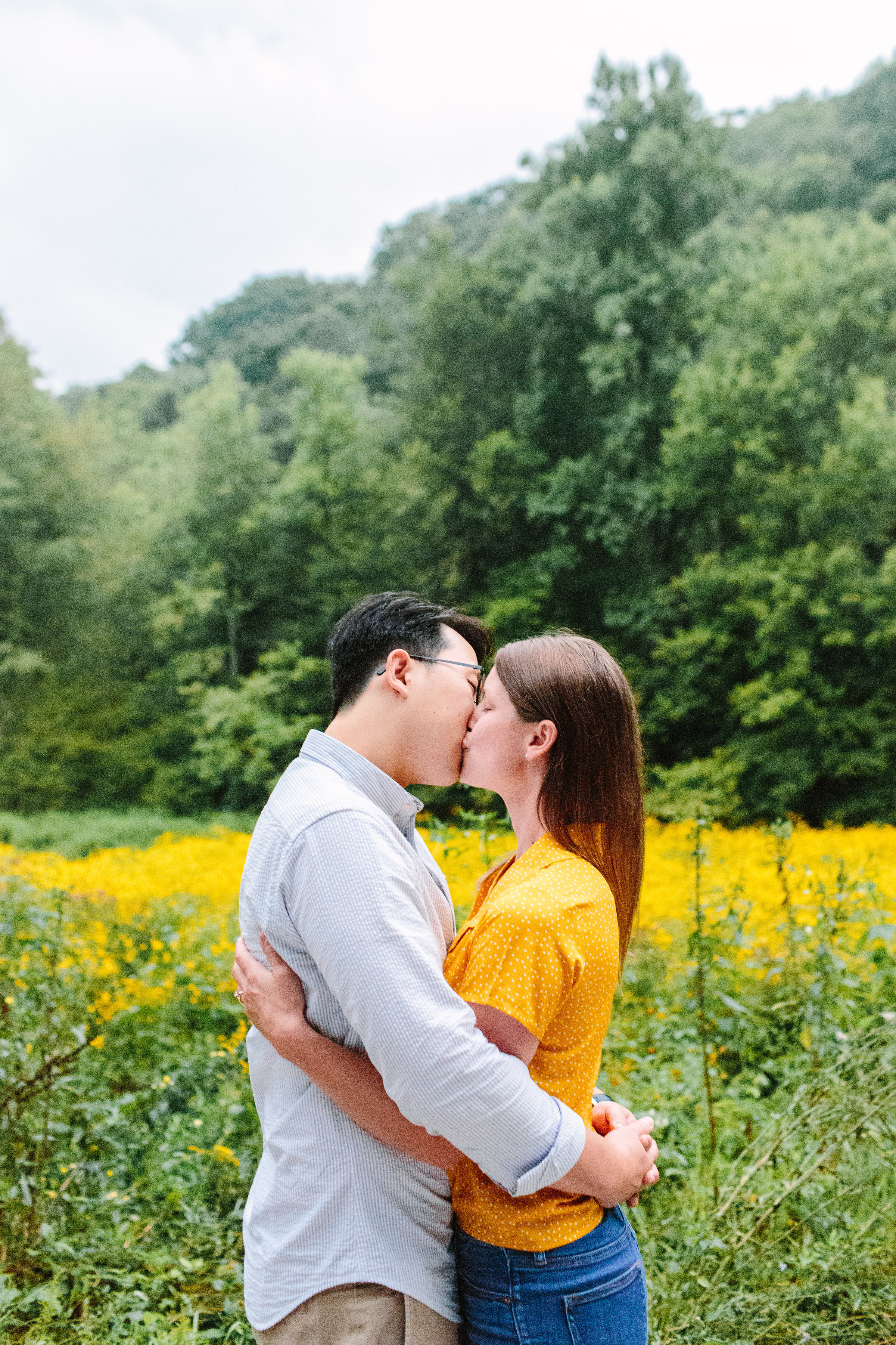 Couple Kissing in Rain | Max Patch Wildflower Rainy Engagement Photos