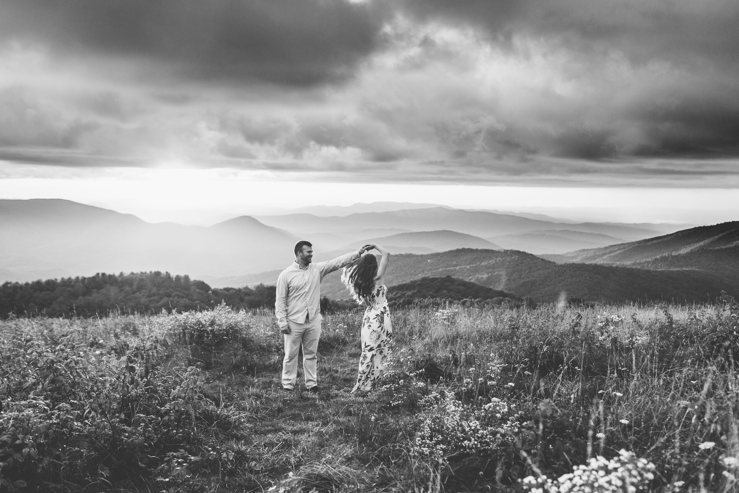 Max Patch Summer Engagement Photos on the Flower-covered Mountaintop | couple dancing on mountaintop