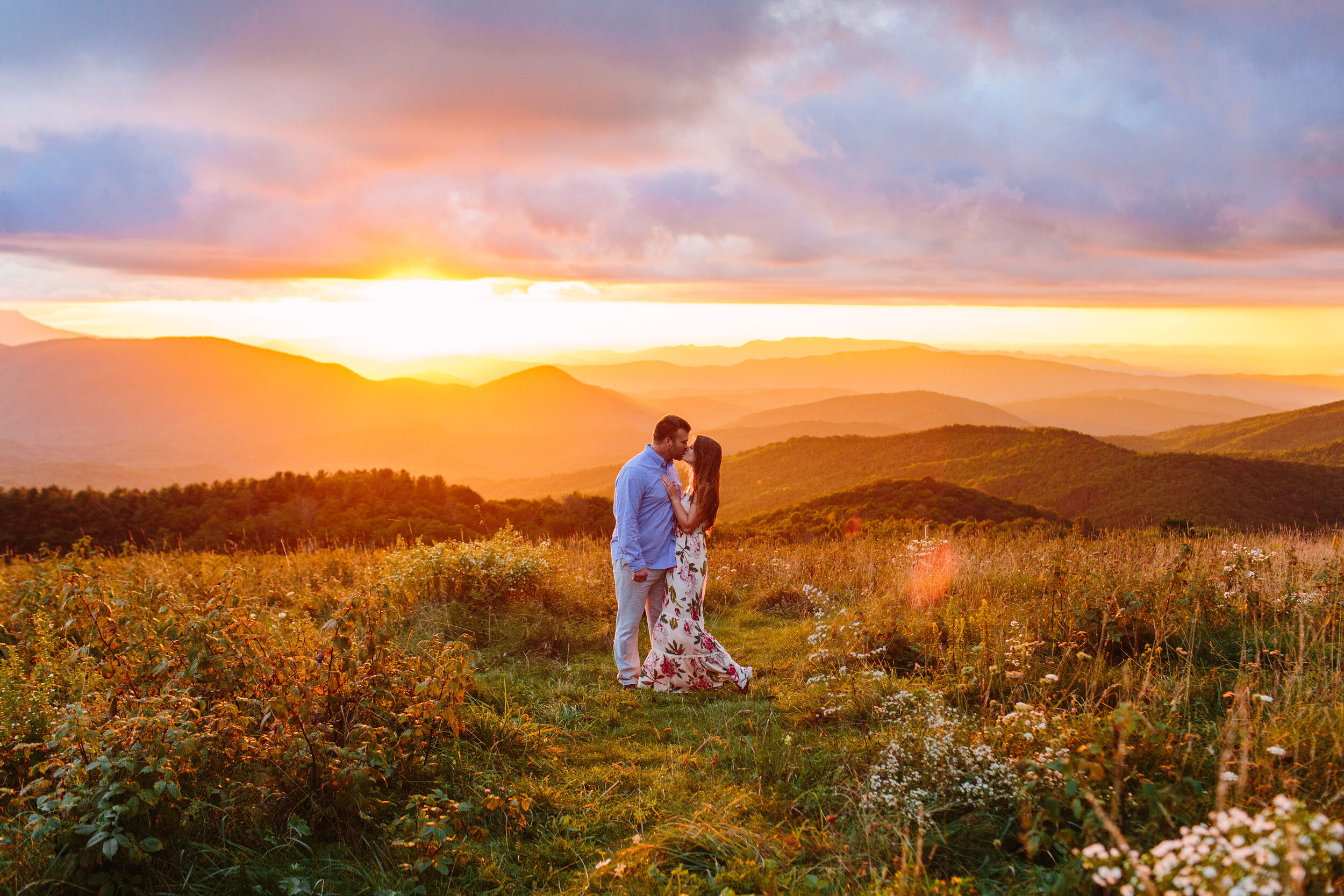 Max Patch Summer Engagement Photos on the Flower-covered Mountaintop | couple kissing