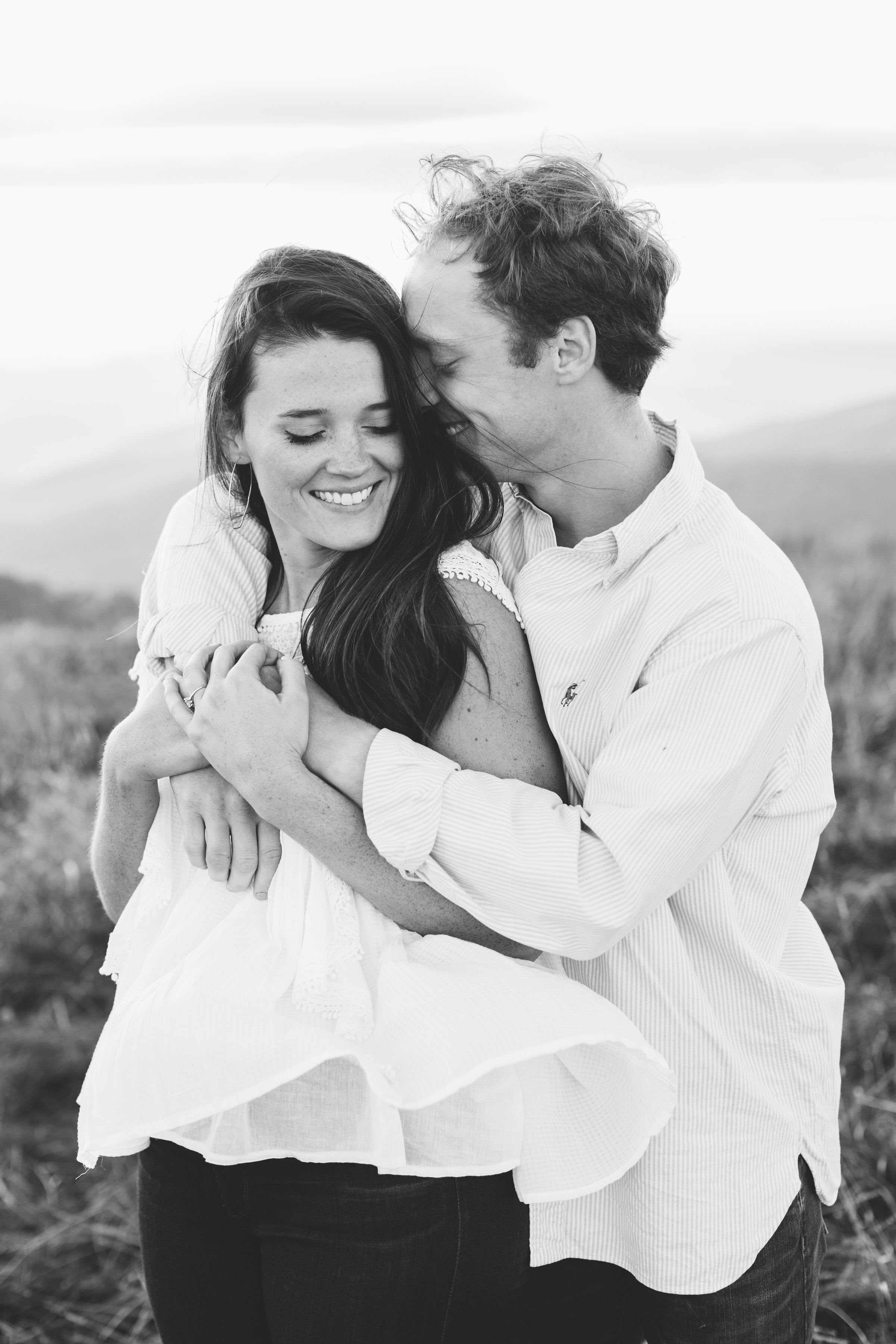 Max Patch Summer Engagement Photos on the Mountain at Sunset | Couple cuddling