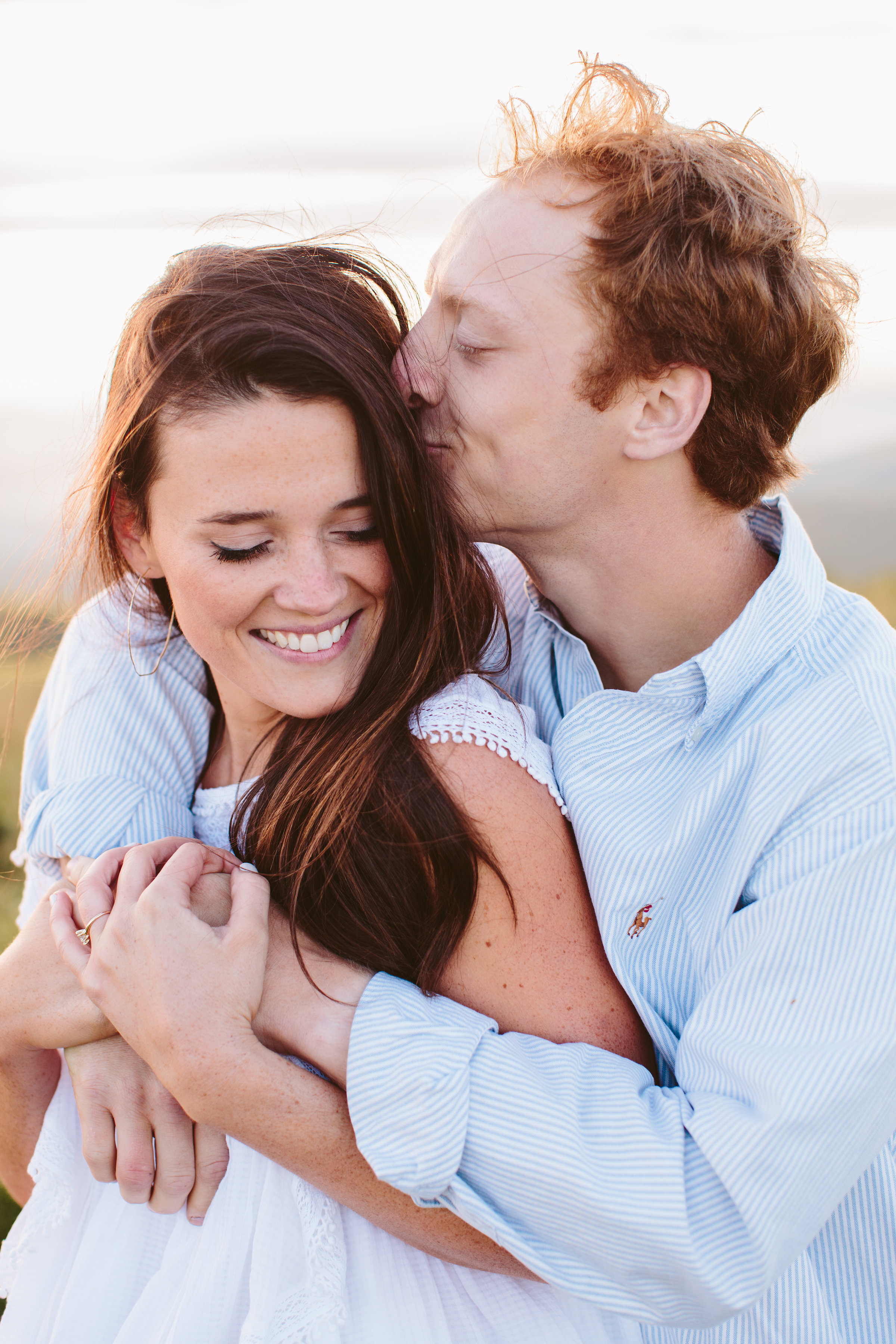 Max Patch Summer Engagement Photos on the Mountain at Sunset | Couple cuddling