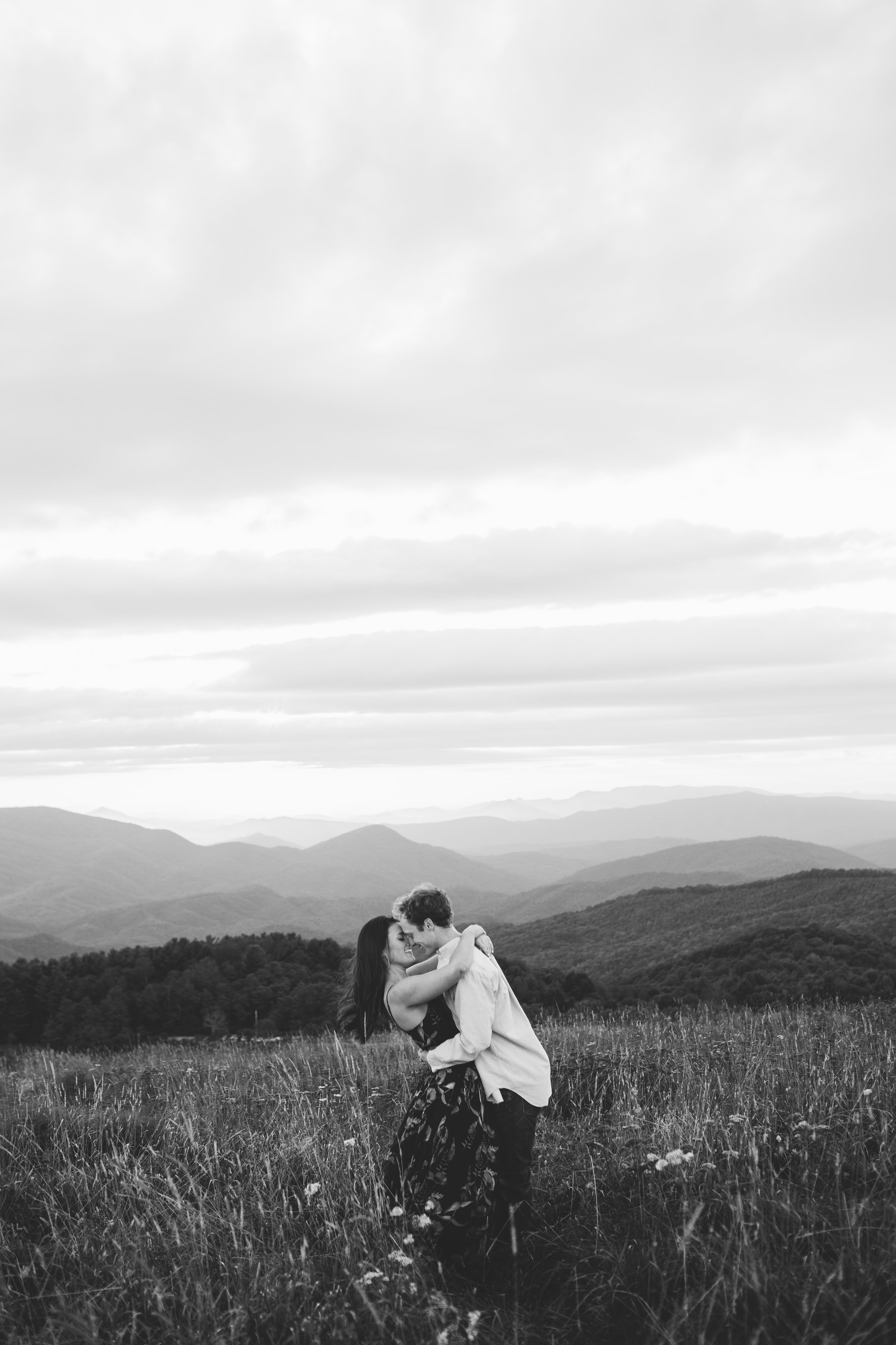 Max Patch Summer Engagement Photos on the Mountain at Sunset couple kissing black &amp; white image