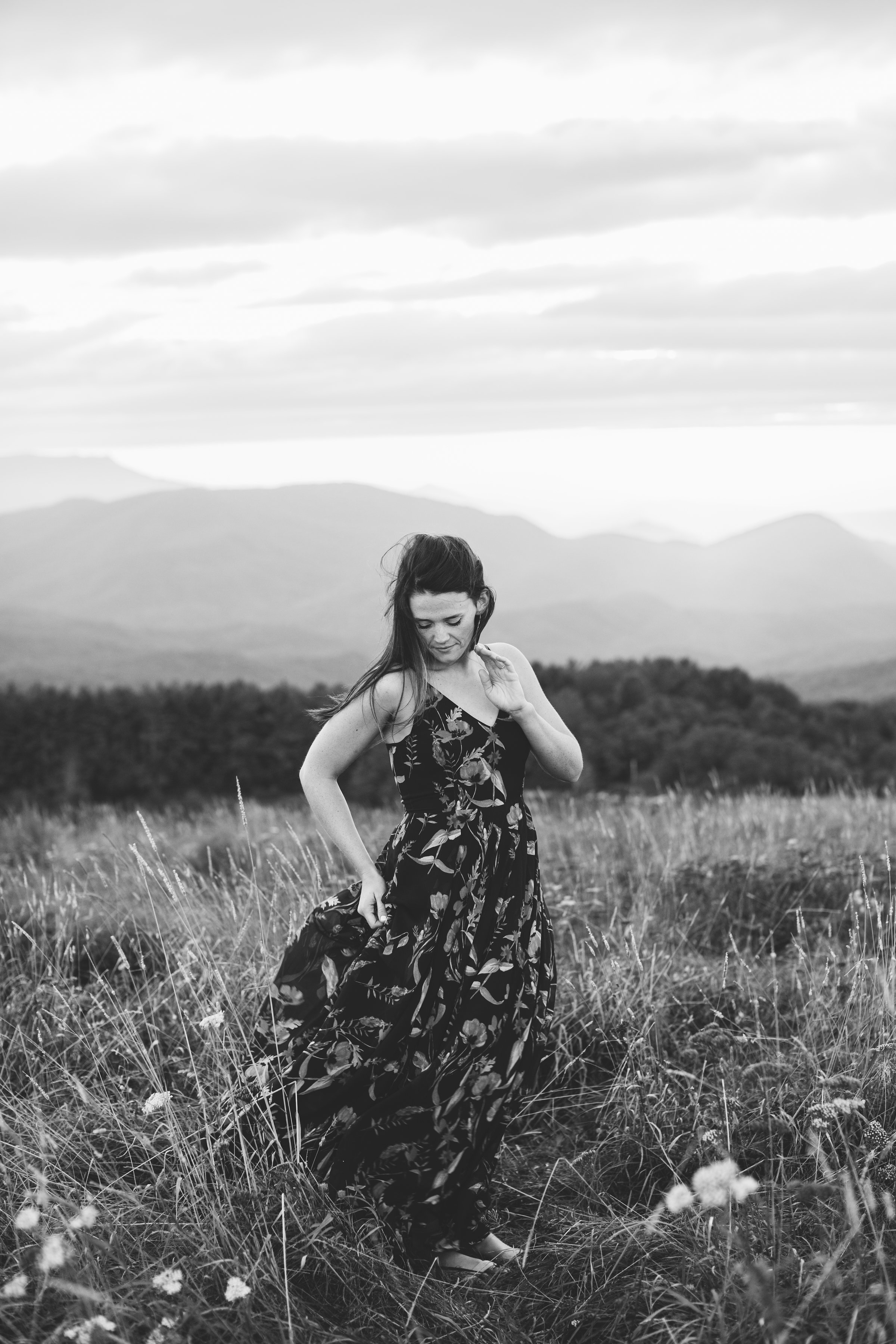 Girl in windblown dress Max Patch Summer Engagement Photos on the Mountain at Sunset