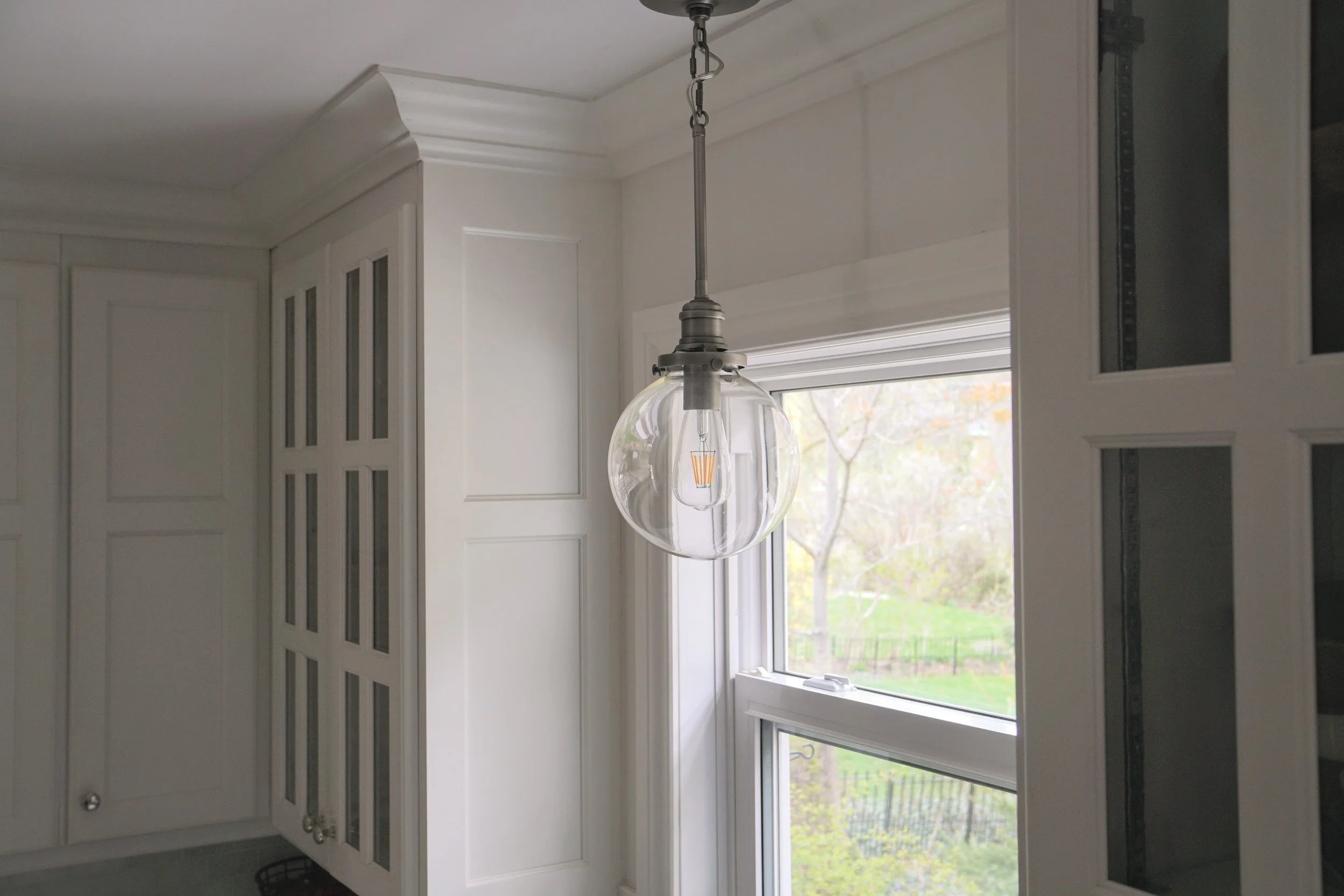 Glass orb over kitchen sink, white dove cabinets to ceiling - Cheryl Lee Interiors