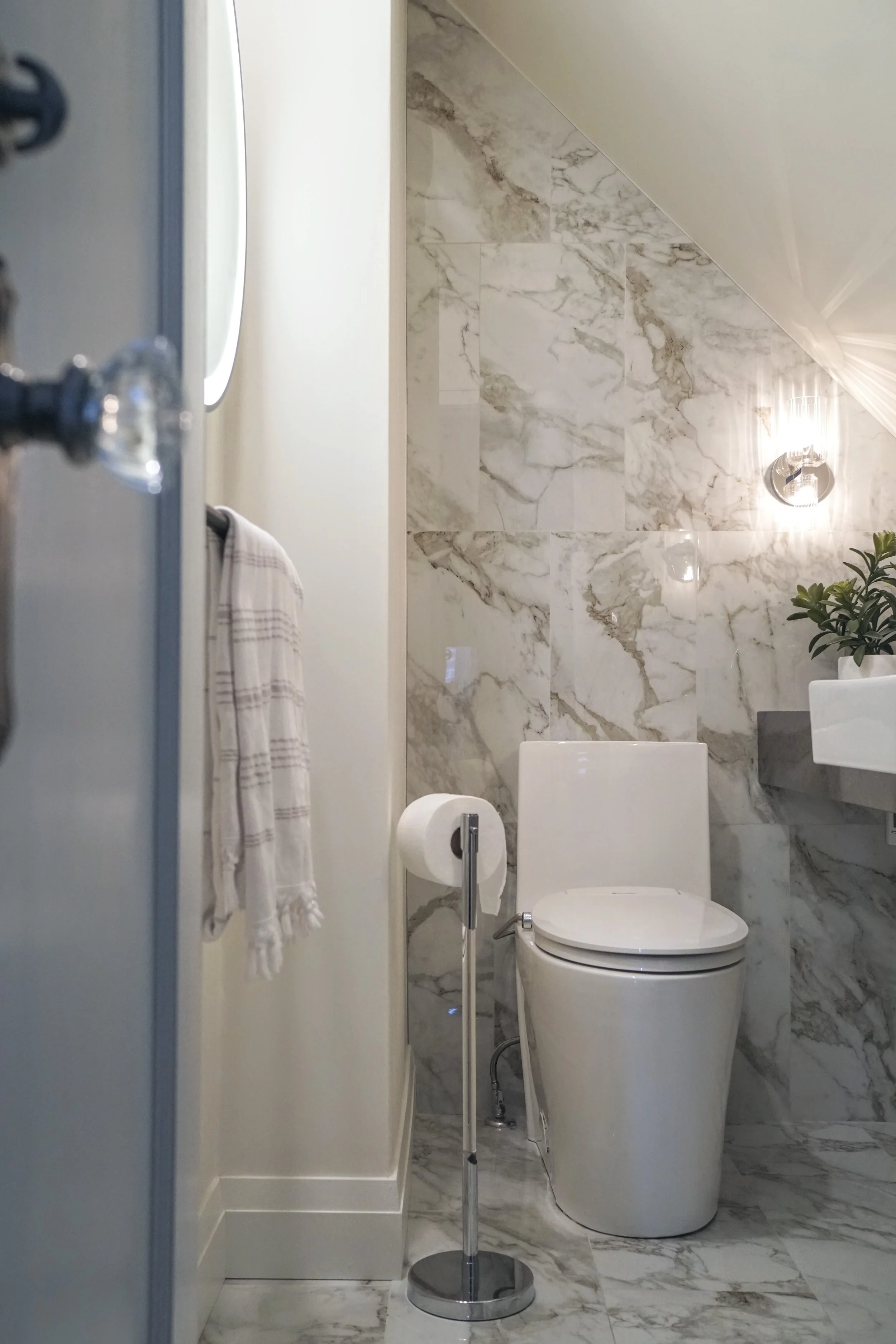 Small water closet, washroom toilet, tiled floor and wall, sloped ceiling - Cheryl Lee Interiors 