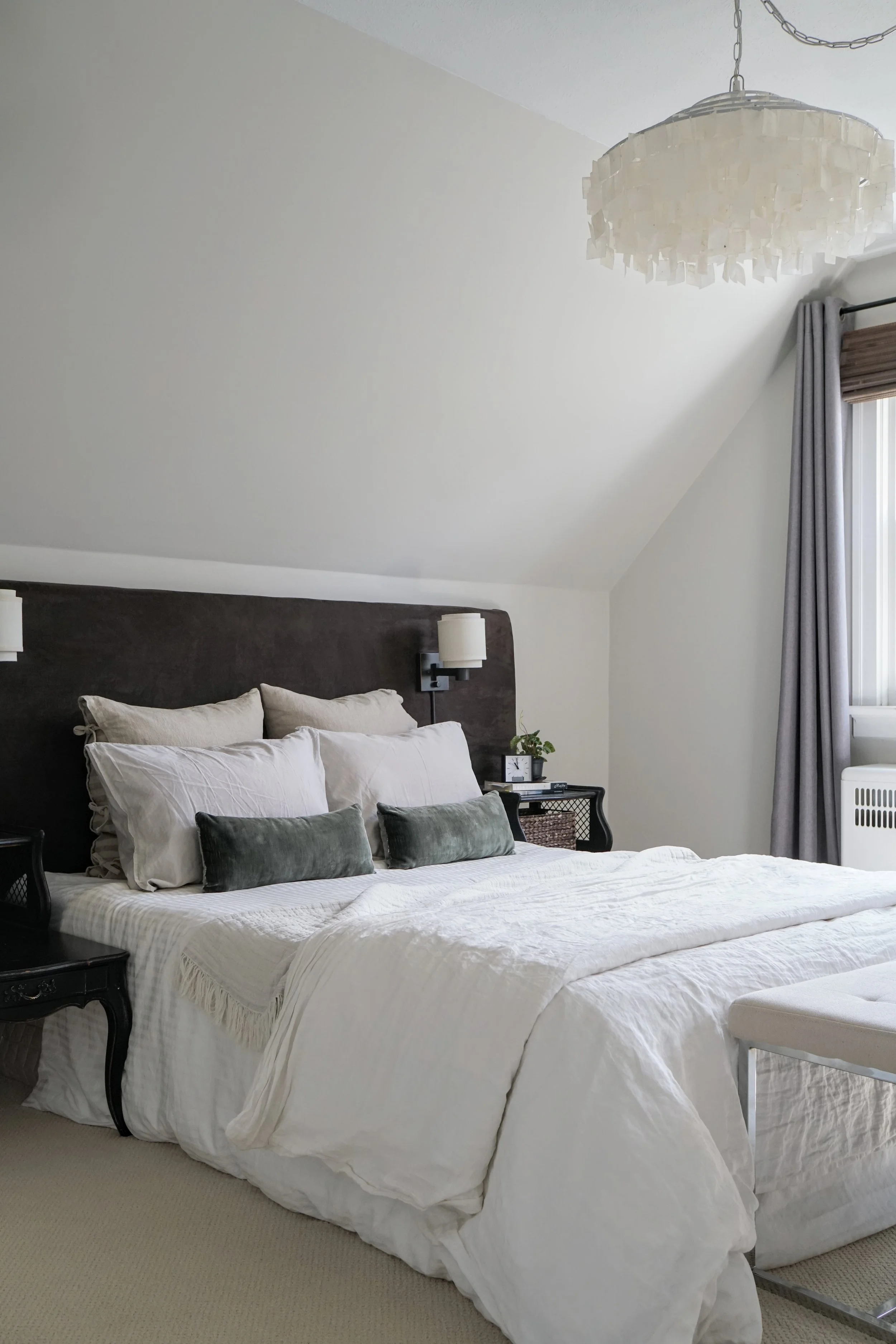Bedroom wide fabric headboard wall sconces, antique night tables, capiz shell chandelier - Cheryl Lee Interiors