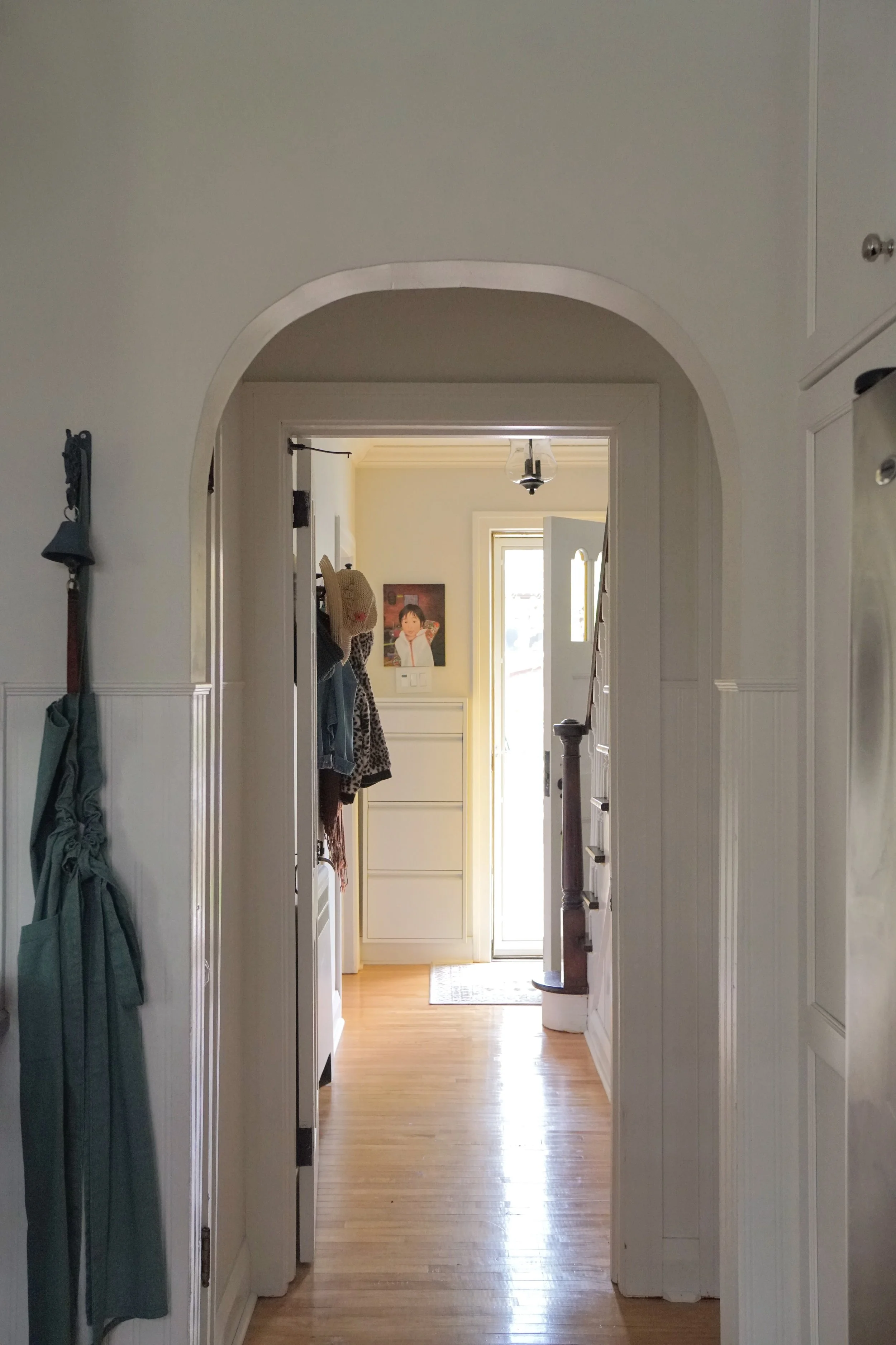 Arched opening beadboard wainscotting narrow hallway - Cheryl Lee Interiors