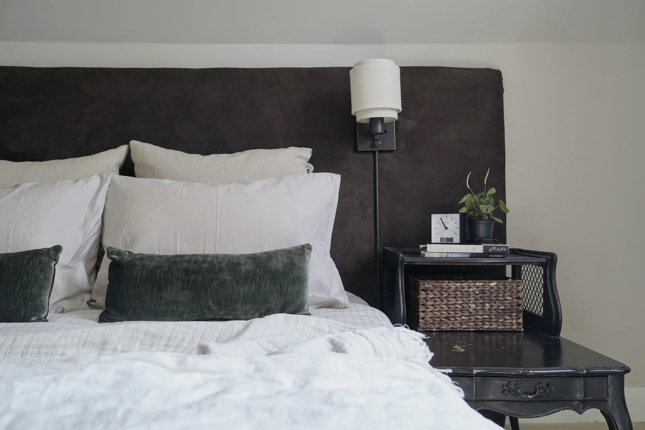 Brown, cream, white, green bed textile palette. antique night stands, wide headboard wall sconces - Cheryl Lee Interiors