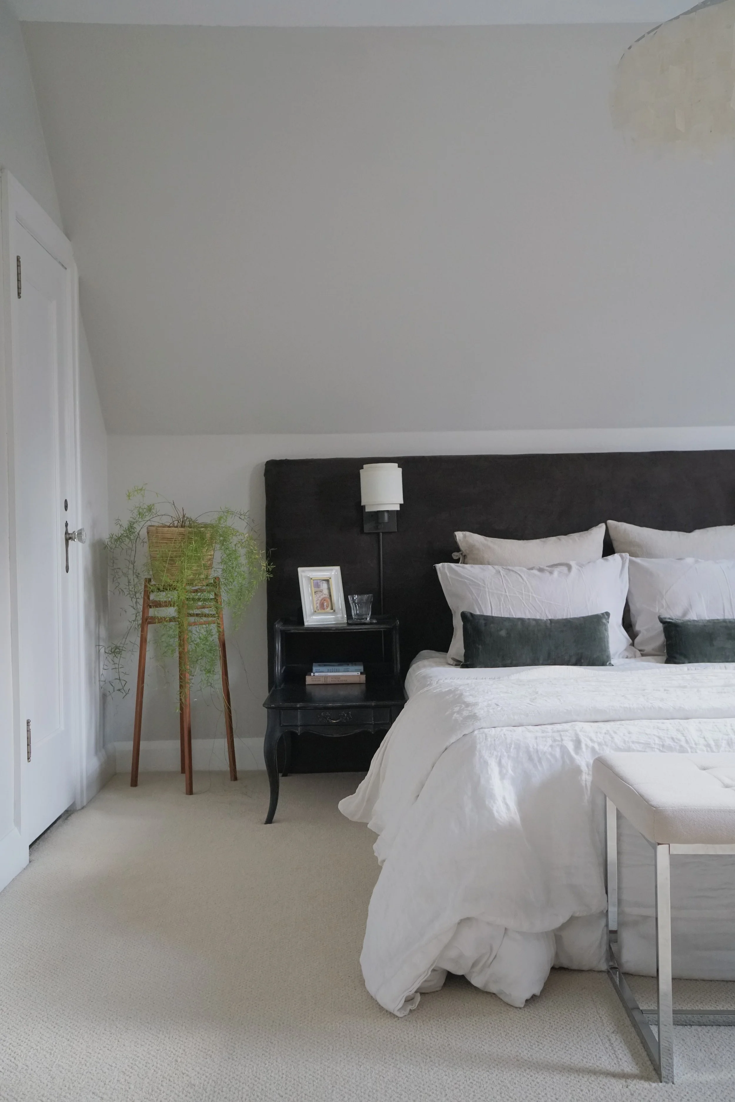 Brown, cream, white, green bed textile palette. antique night stands, wide headboard wall sconces - Cheryl Lee Interiors