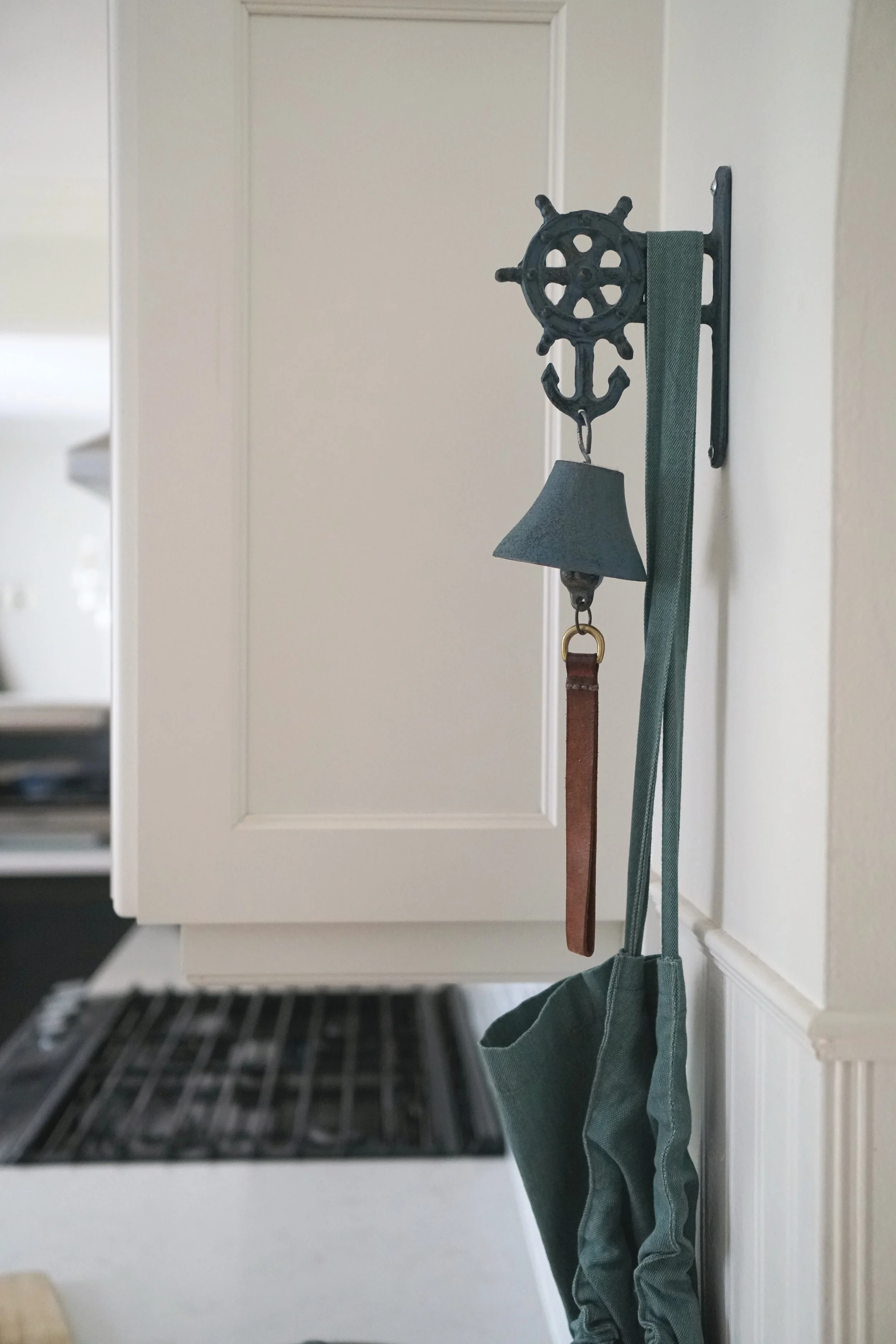 Cape cod lakeside blue dinner bell apron hanging - Cheryl Lee Interiors