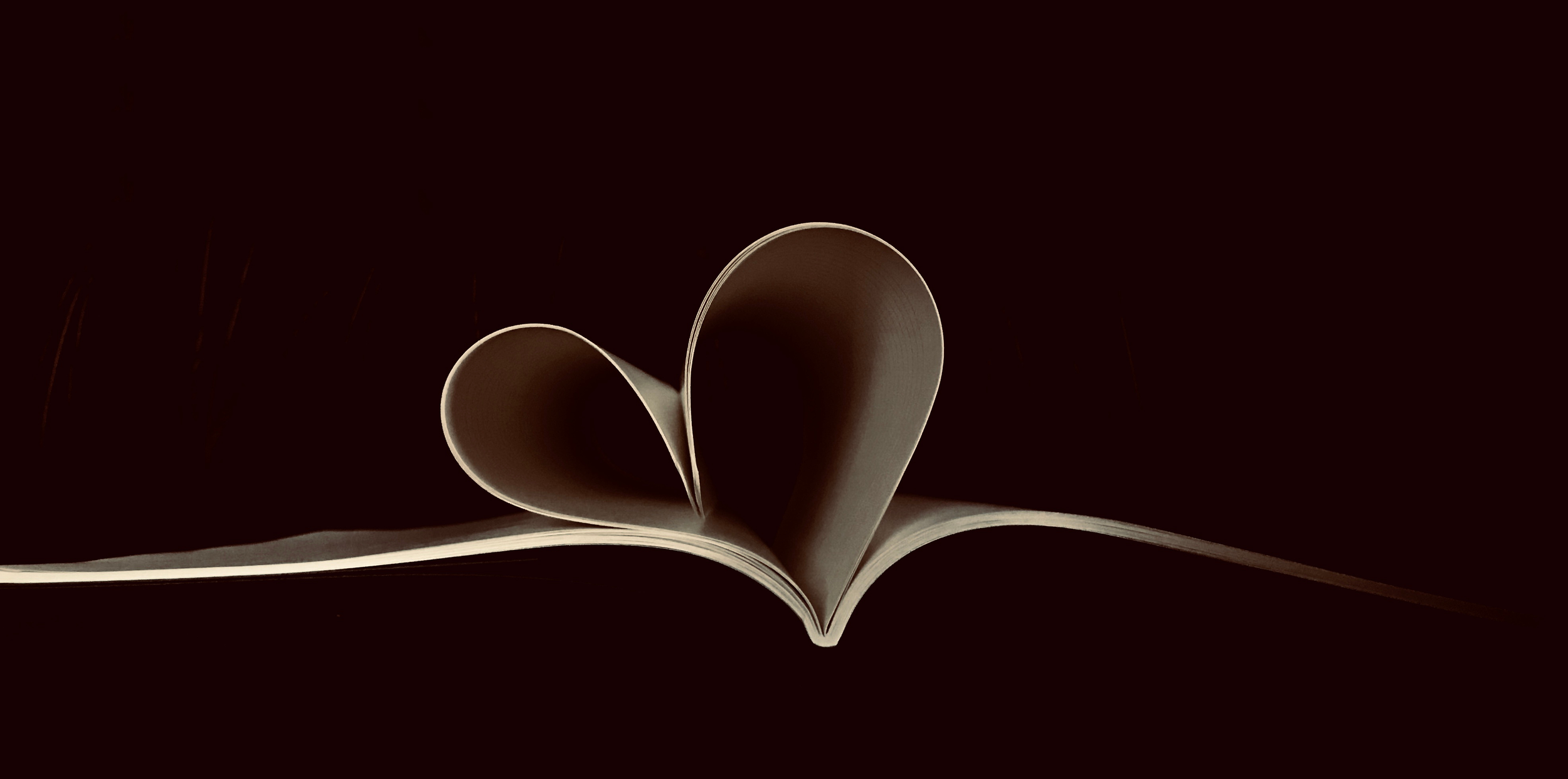 Book pages forming a heart.