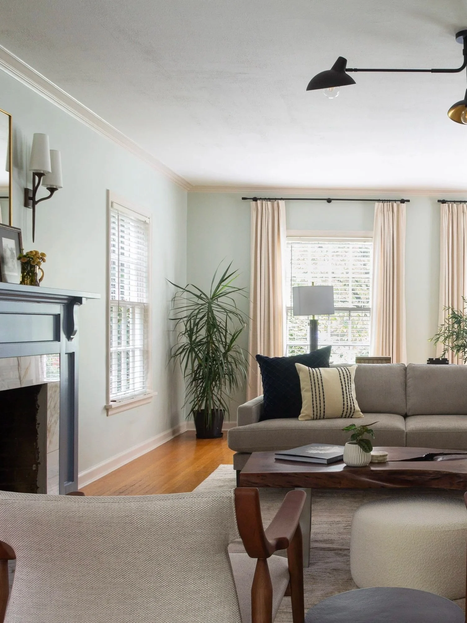 Bright living room with neutral furnishings, soft textiles, and layered lighting in a thoughtfully designed Portland home.