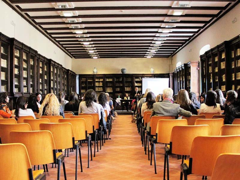 Professionals attend an educational workshop on technology, cybersecurity, or AI in a university-style lecture hall.