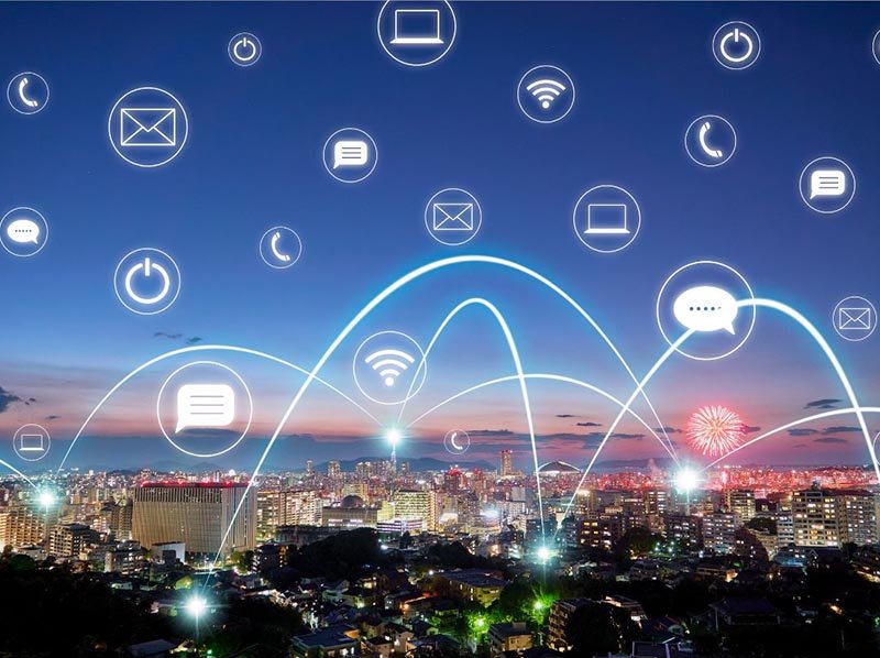 City skyline at dusk with glowing network icons and connecting lines, illustrating digital connectivity and smart technology.