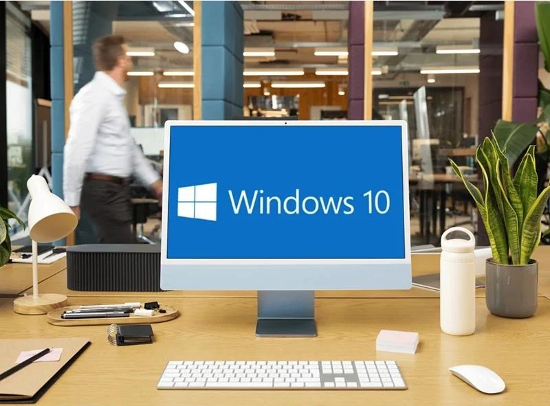 Desktop computer displaying Windows 10 on a modern office desk.