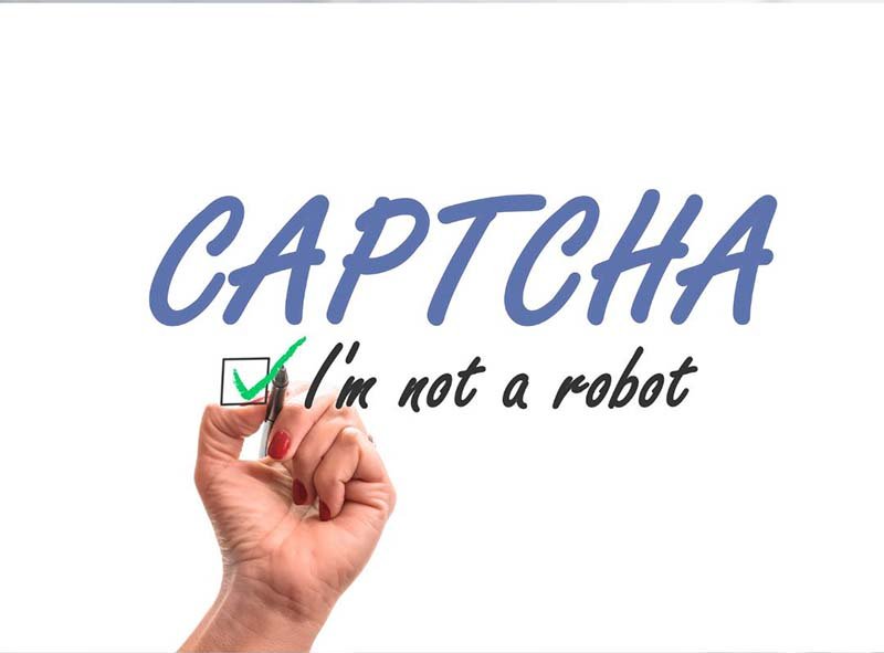 Hand checking a box with a green check confirming with CAPTCHA that they are not a robot.