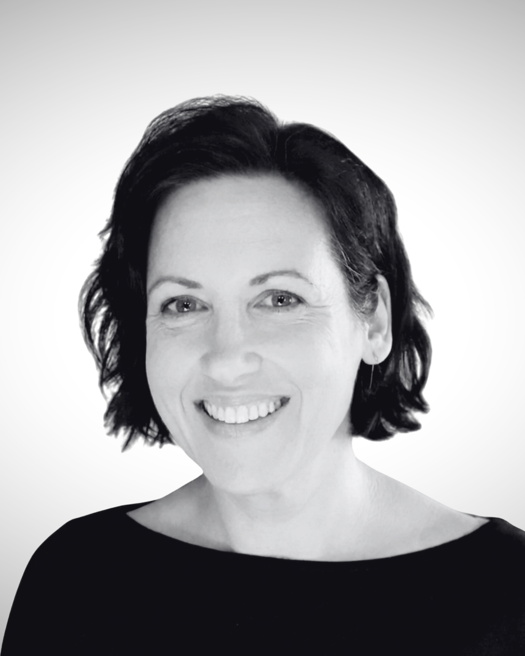 Black and white photo of a woman with short dark hair, smiling