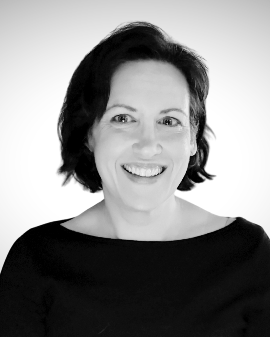 Black and white photo of a woman with short dark hair, smiling