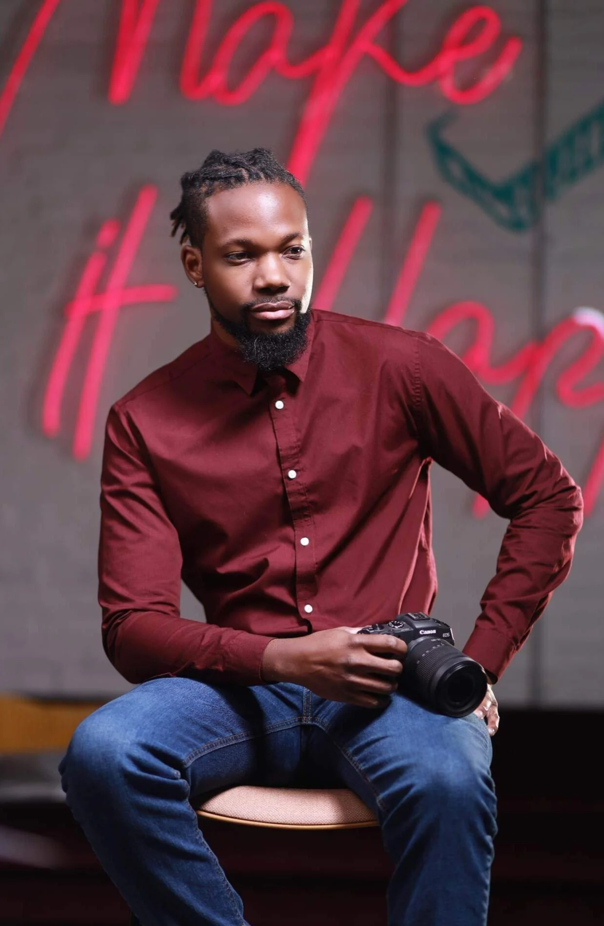 wedding photographer posing with camera in hand