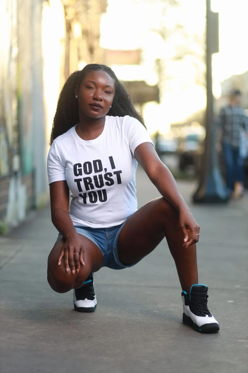 female squat posing with God I trust you white shirt 