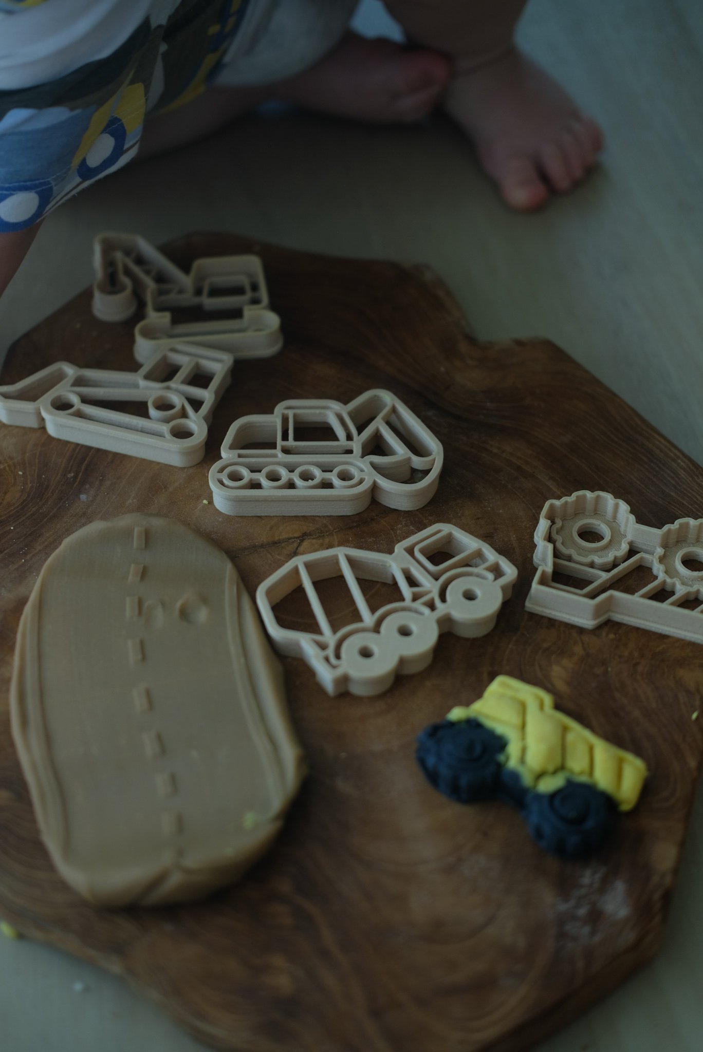 Playdough pressed with excavator and dump truck cutters — eco construction tools for open-ended play.