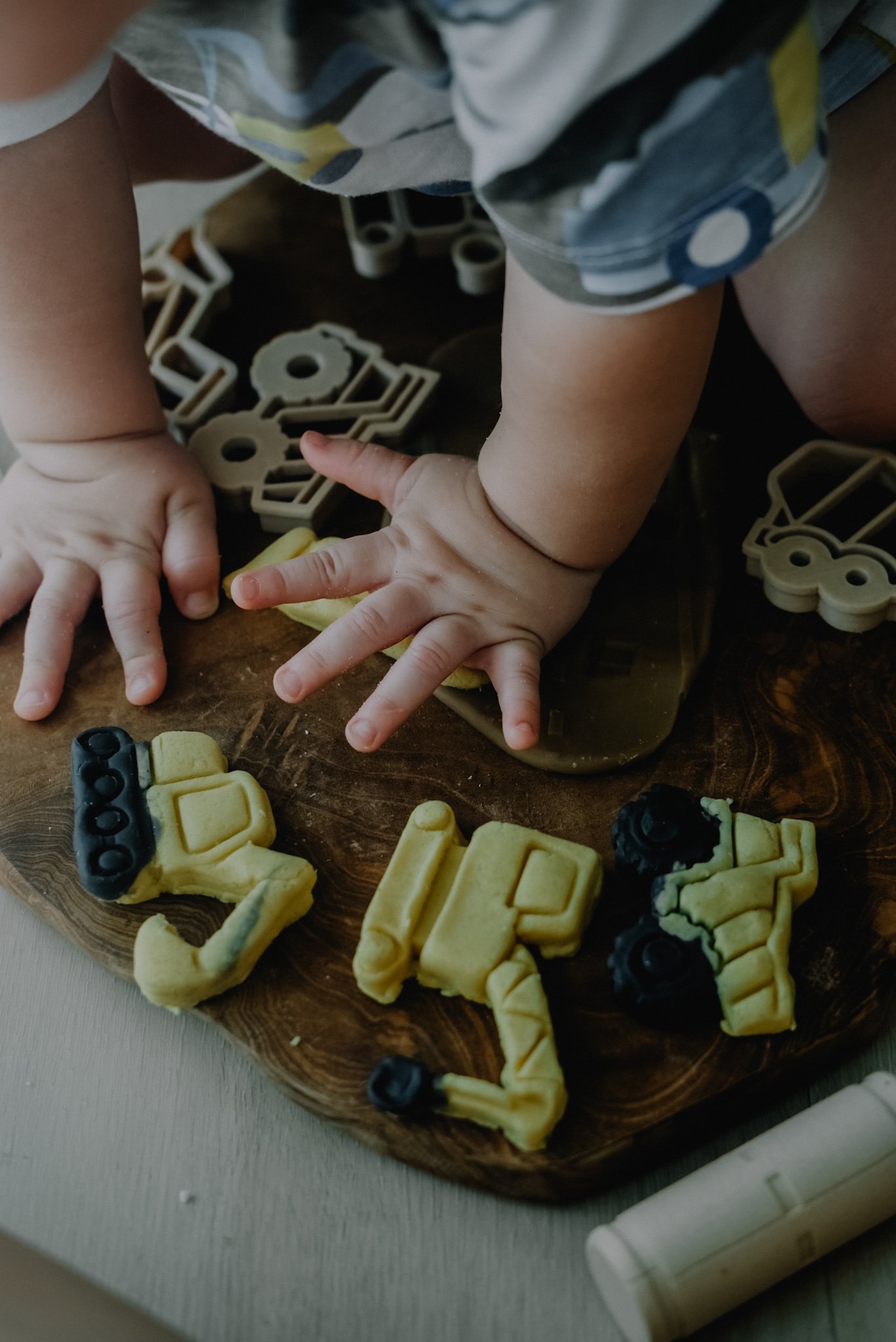Toddler hands exploring construction cutters — sensory play with Australian made eco cutters.
