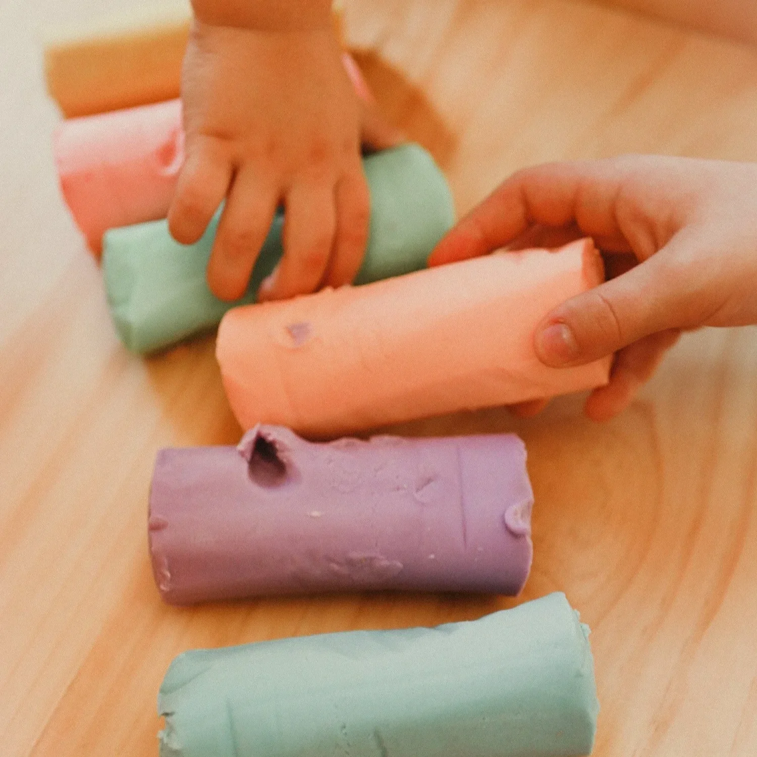 Little hands playing with Pastel coloured playdough