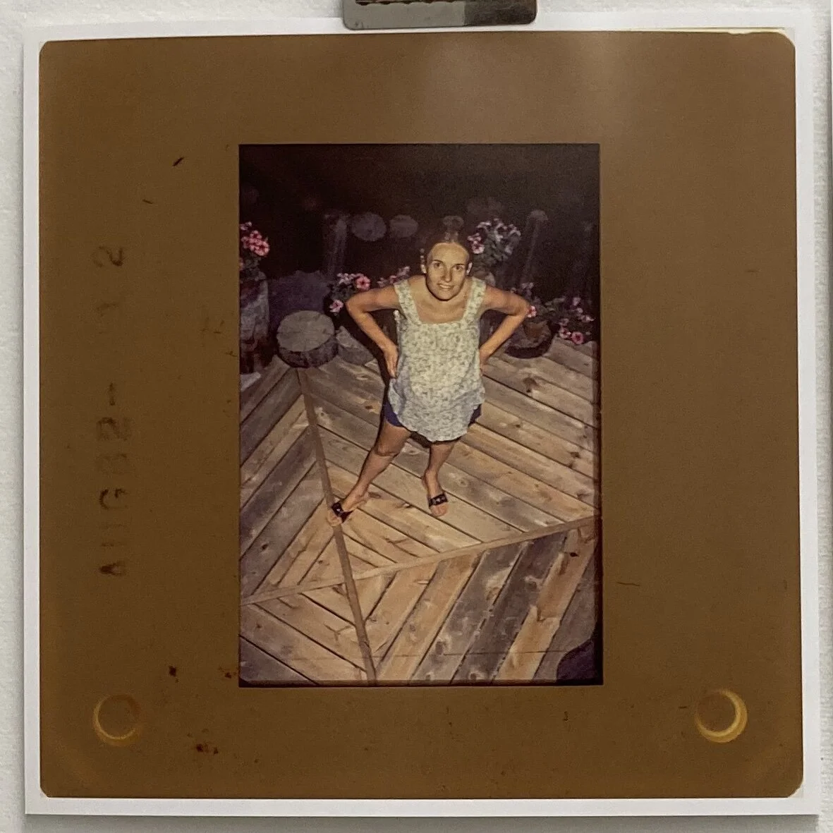  This image of my mother is beautiful.  I’ve never known her as young, she was already rather old when I was born so I was never around when my mother looked like this. Seeing her in this way is rather odd. Also, something about the wood deck is both
