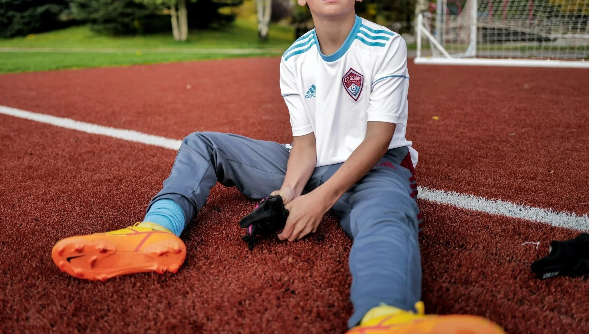 teen football sitting on ground