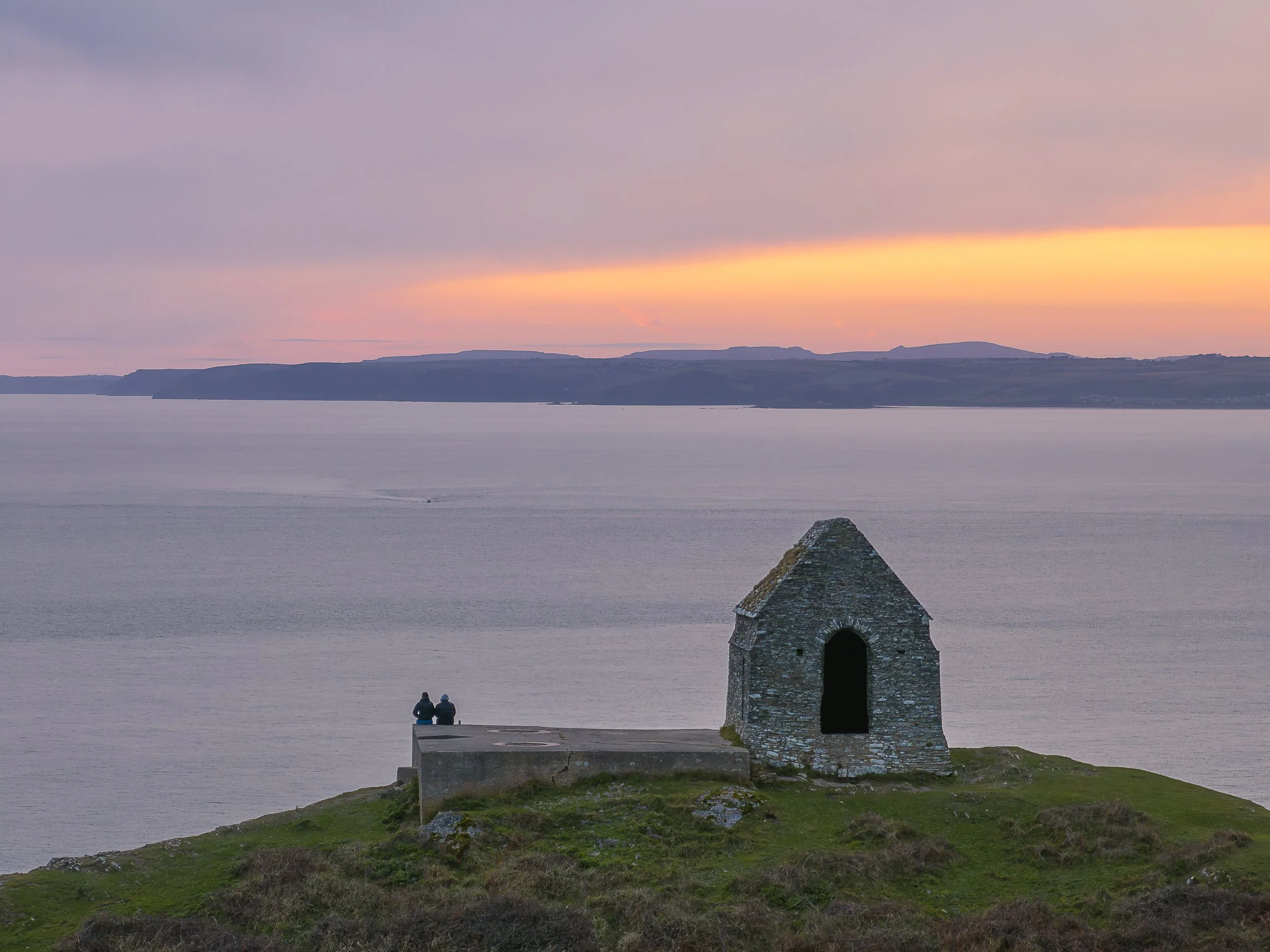 Rame Head chapel that is an intact shell and was originally lime-washed so that it stood out on the headland - sunset