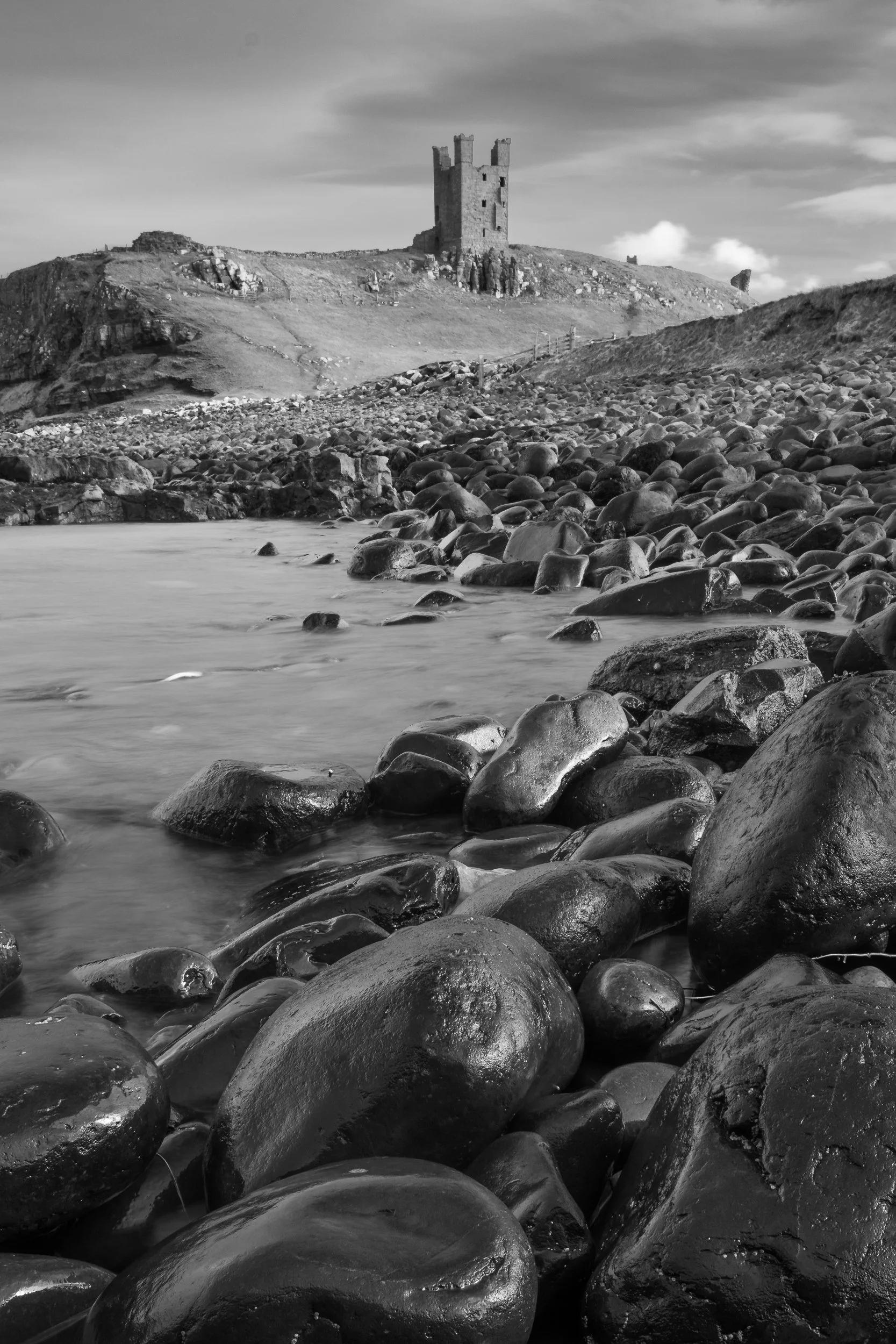 Dunstanburgh wet boulders