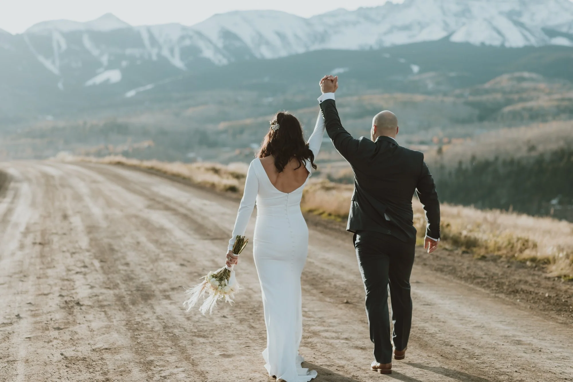  a bride and groom celebrate during their colorado mountain elopement on their telluride co wedding day. 