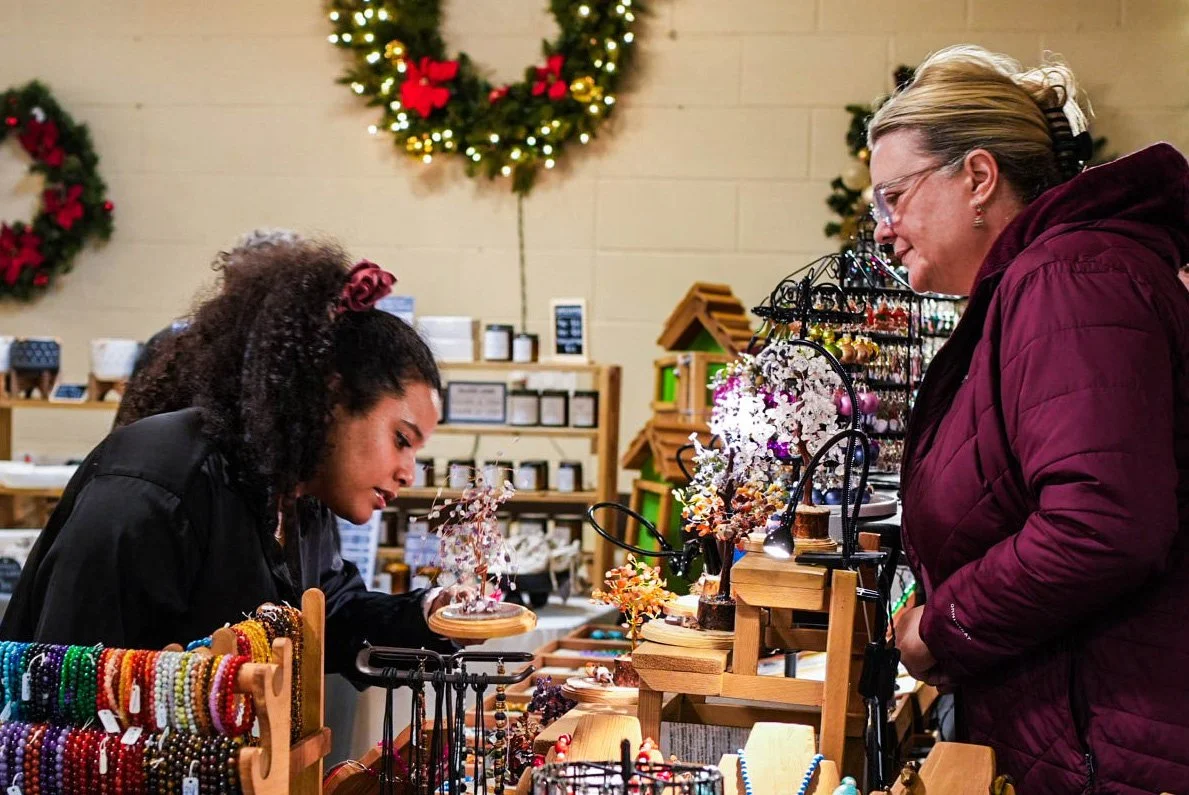 Shoppers browsing handmade goods at an artisan stall