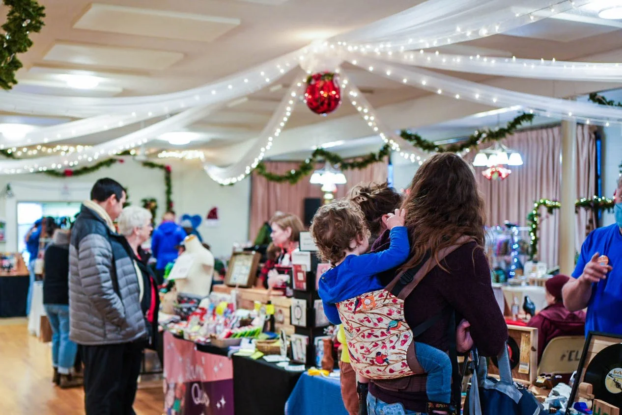Visitors browsing the stalls at Nanaimo Christmas Village, an official Great Nanaimo Toy Drive drop-off location