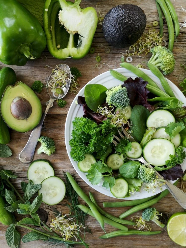 plate of green vegetables on table full of them