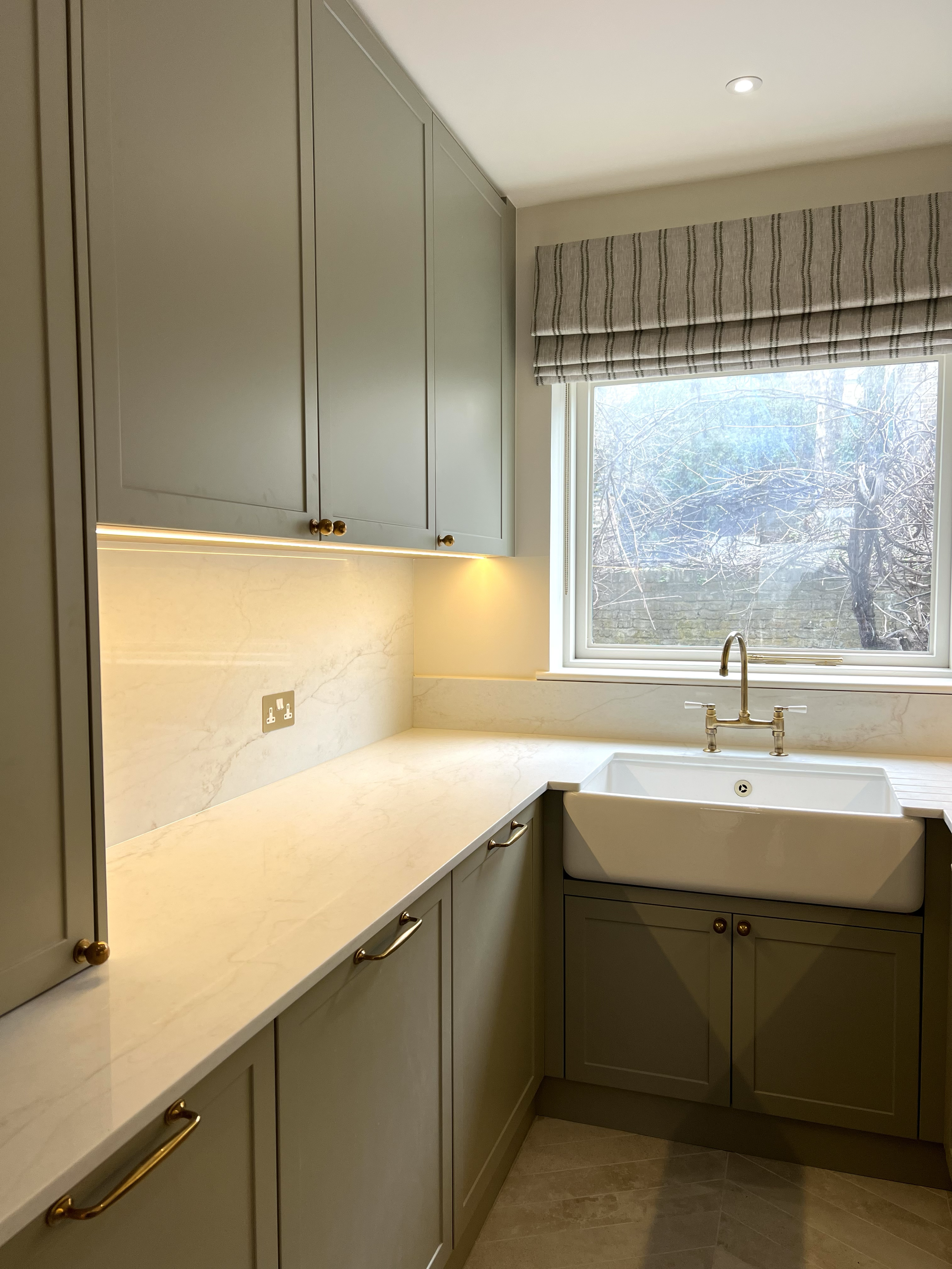 “Bespoke kitchen design with shaker-style cabinets, stone countertops, and integrated appliances.”