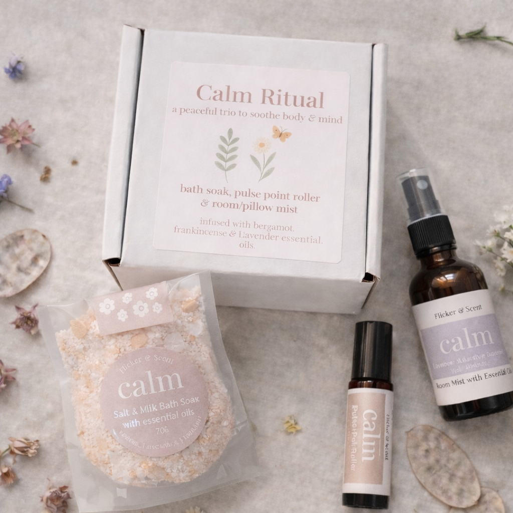 Calm Ritual essential oil gift set with bath soak, pulse point roller and pillow mist on rustic linen flatlay for relaxation and wellbeing