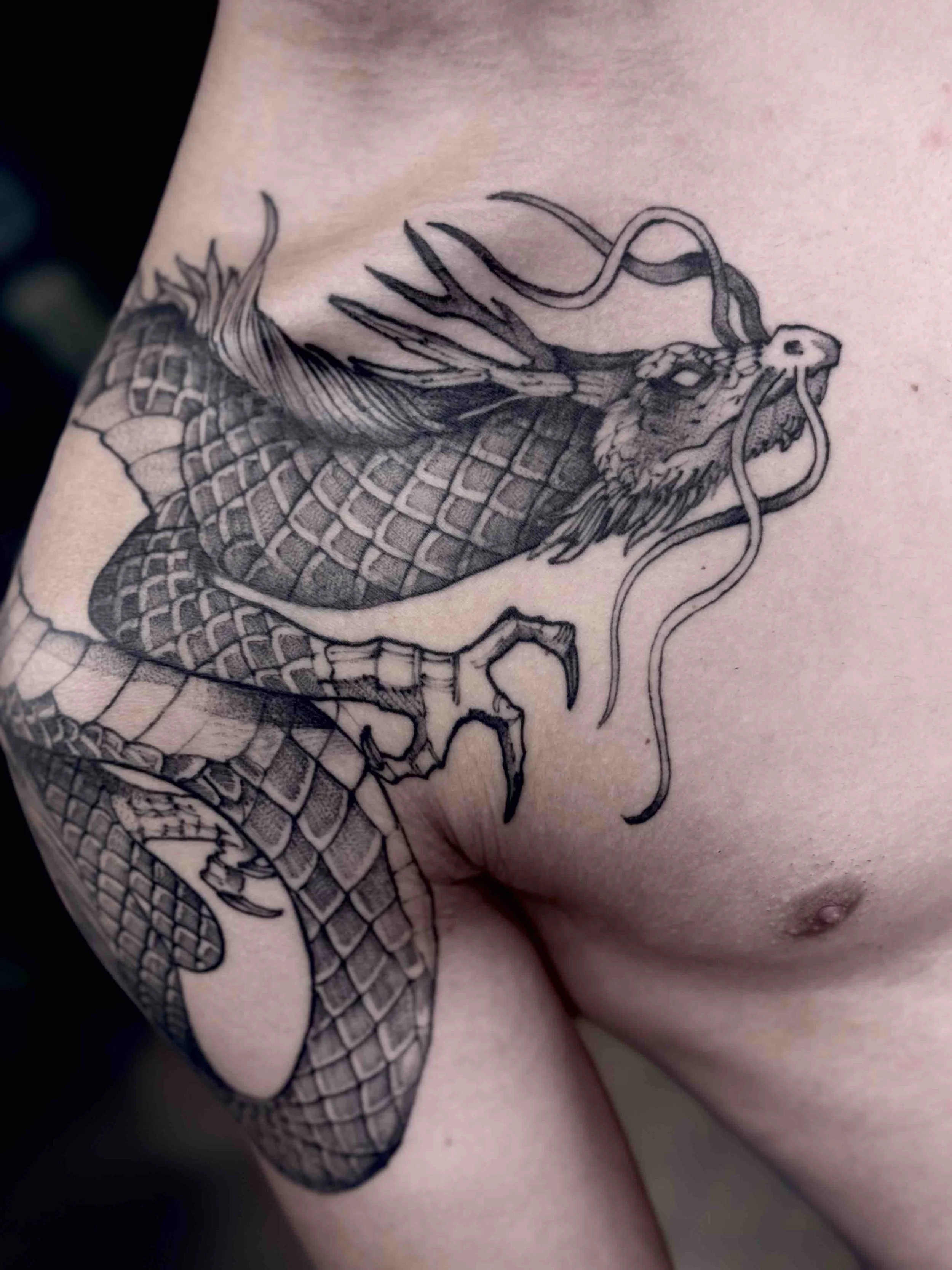 blackwork-linework-shoulder-dragon-tattoo.jpeg