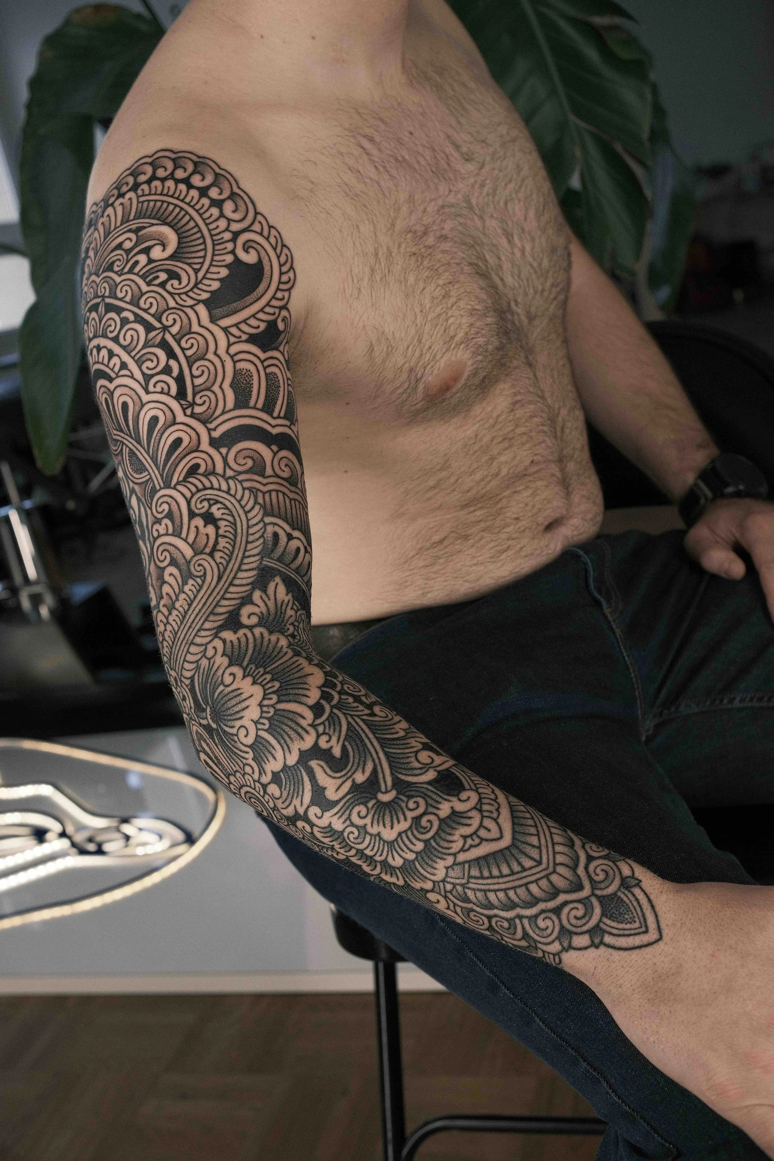 full-arm-sleeve-mandela-tribal-inspired-blackwork-tattoo.jpeg