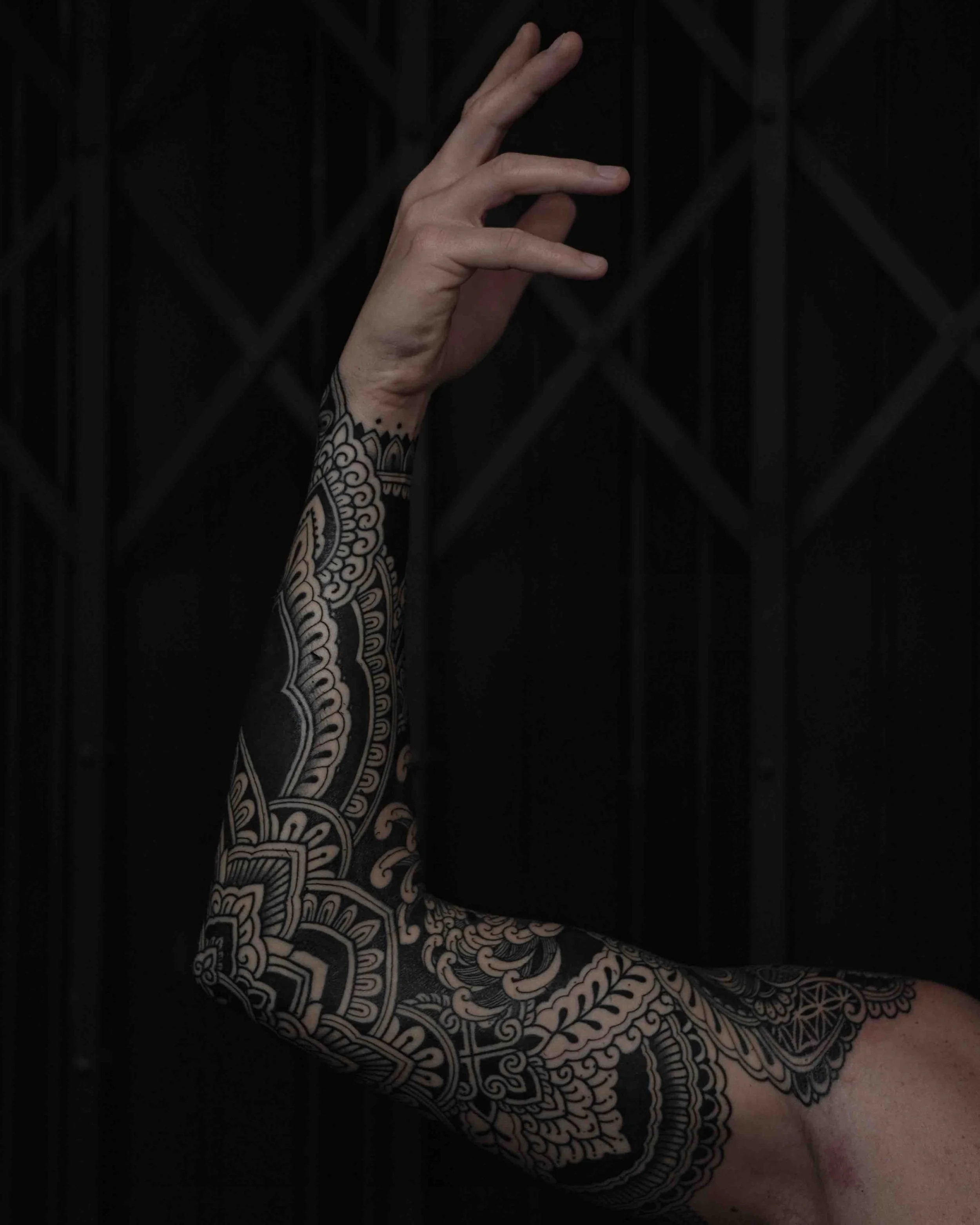 full-sleeve-blackwork-arm-tattoo.jpeg